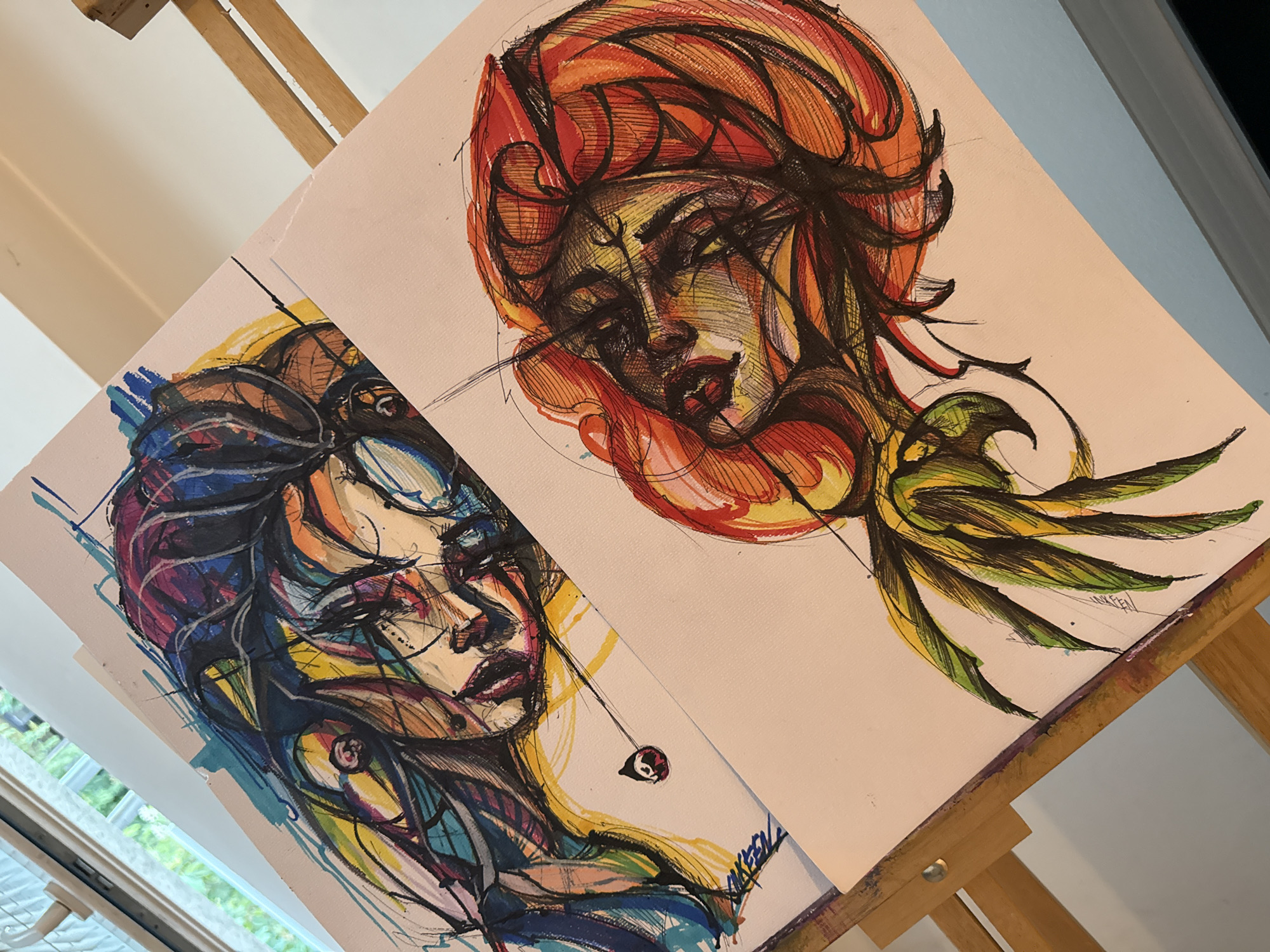 Colorful portrait drawings displayed on easel in Sofia