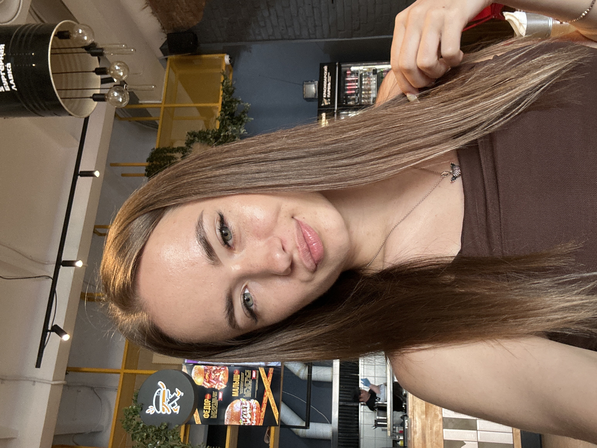 Woman documents restaurant meal with selfies and food photos