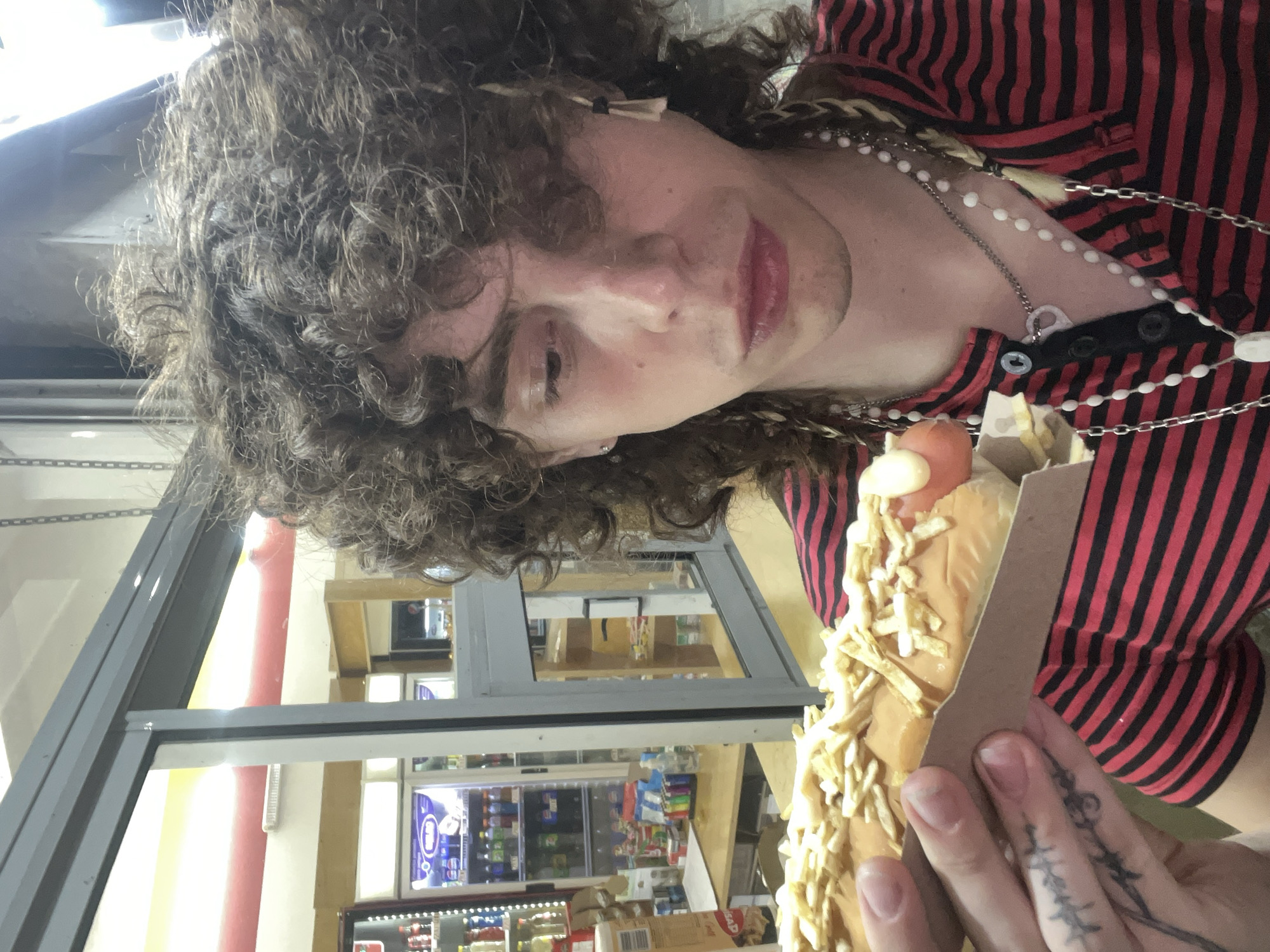 Concertgoer enjoys hot dog during live music performance in Buenos Aires