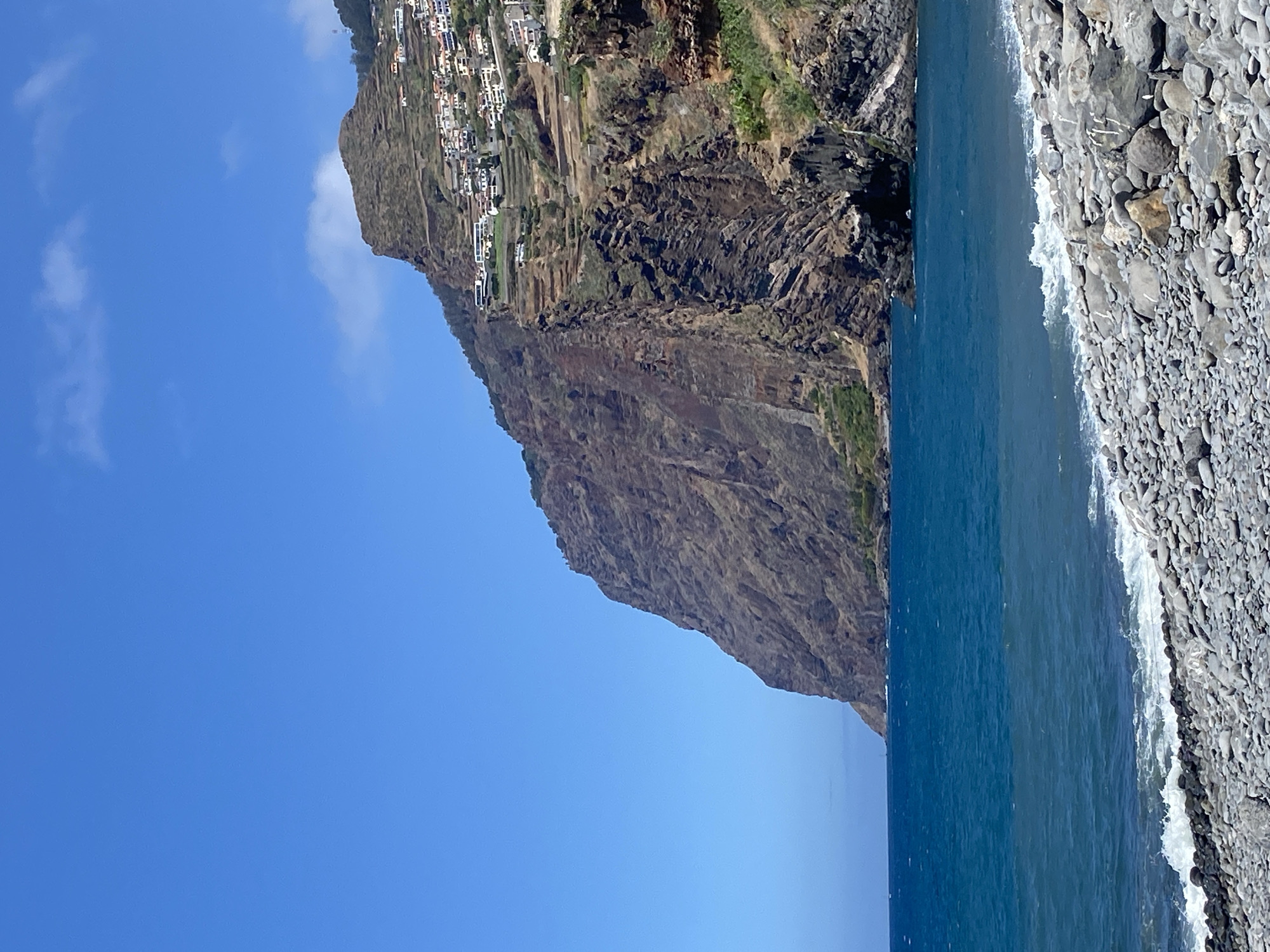 Câmara de Lobos beach, cliffs, boardwalk, and streets on a summer morning