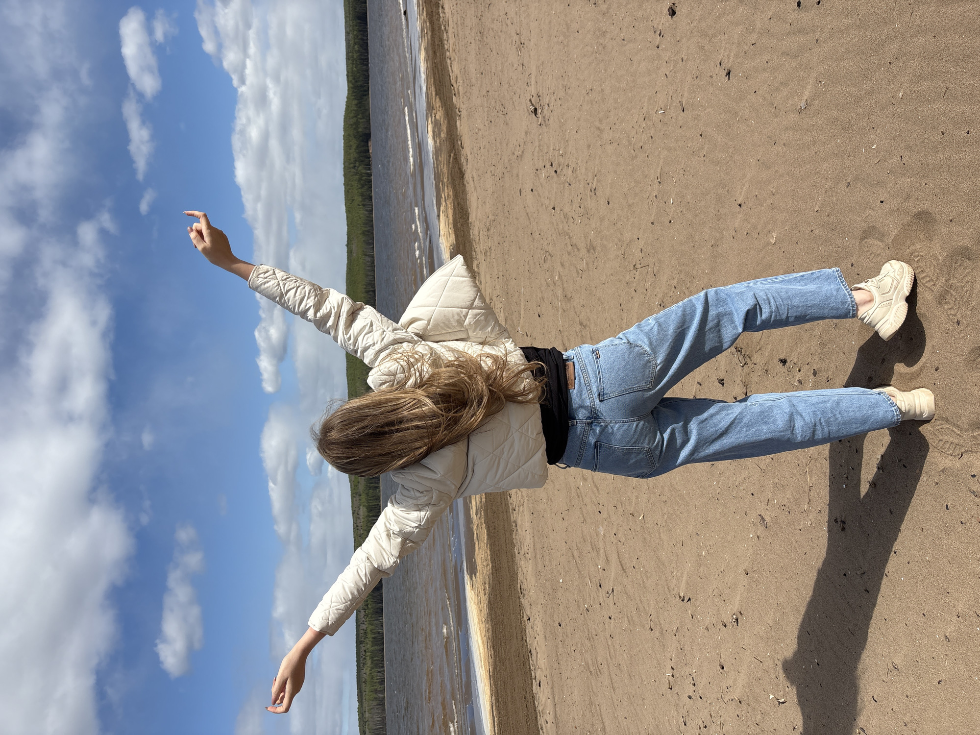 Woman enjoys morning beach visit at Kama Reservoir, Russia