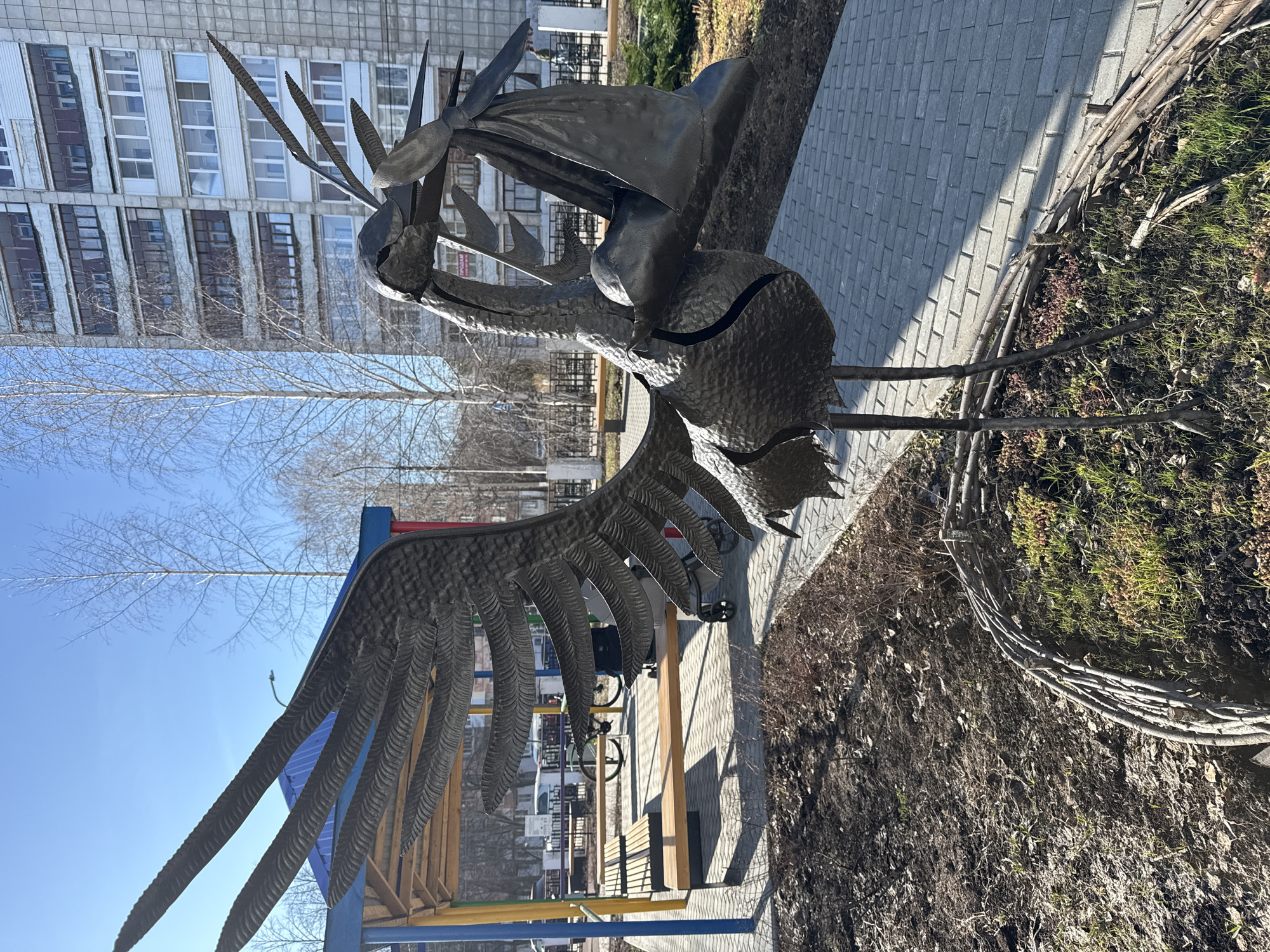 Urban spring morning: bird sculptures, nesting sparrow, city streets