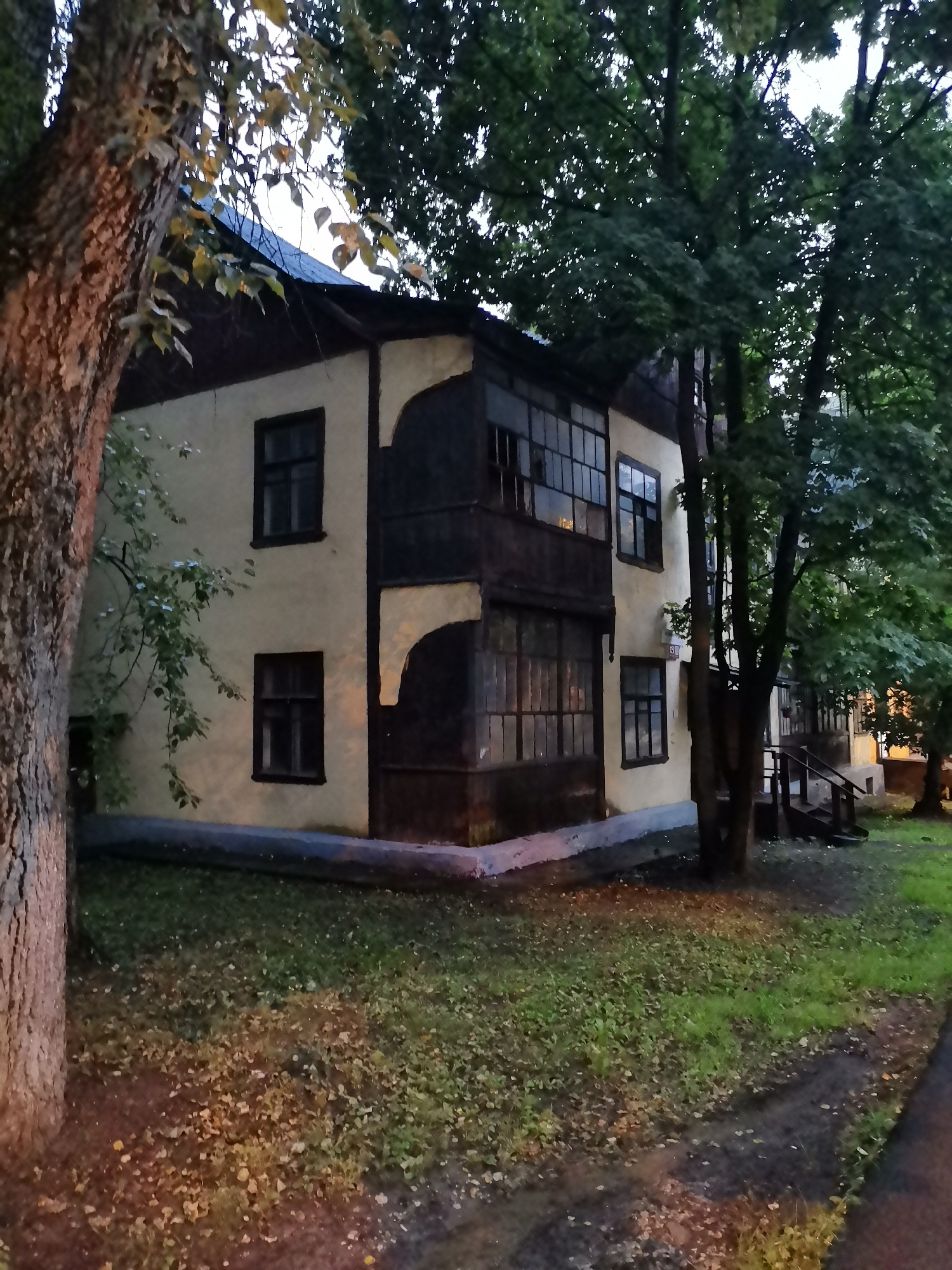 Wet evening streets and local buildings in Krasnogorsk, Russia