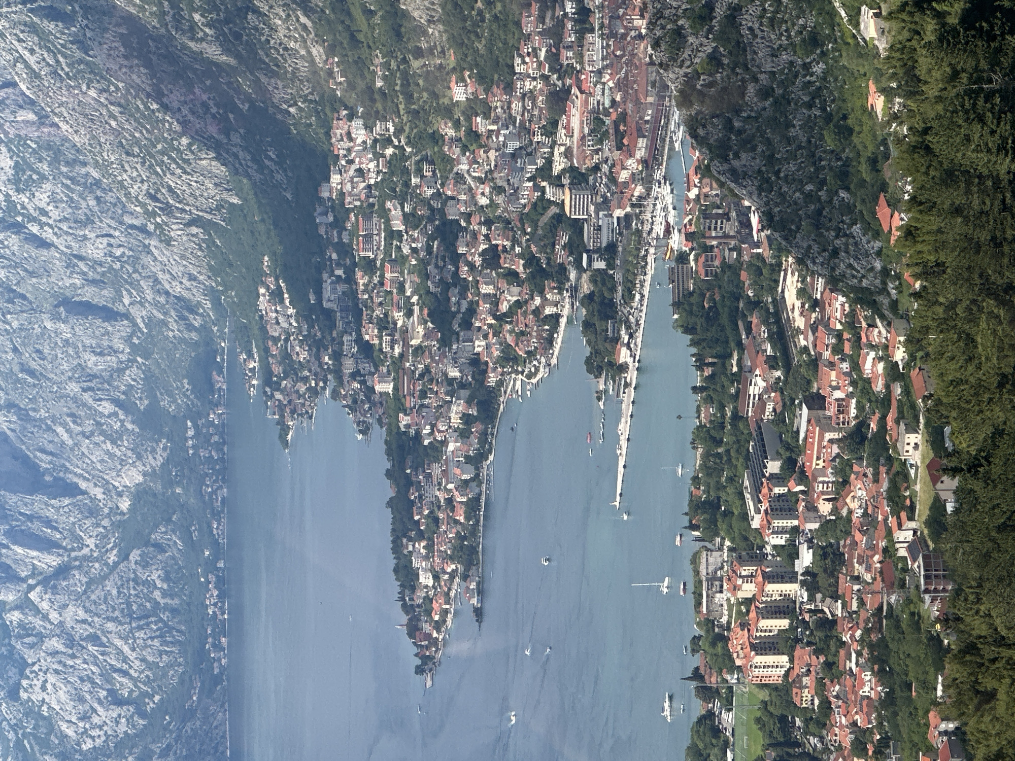 Tourists ride cable cars over scenic Kotor Bay, Montenegro