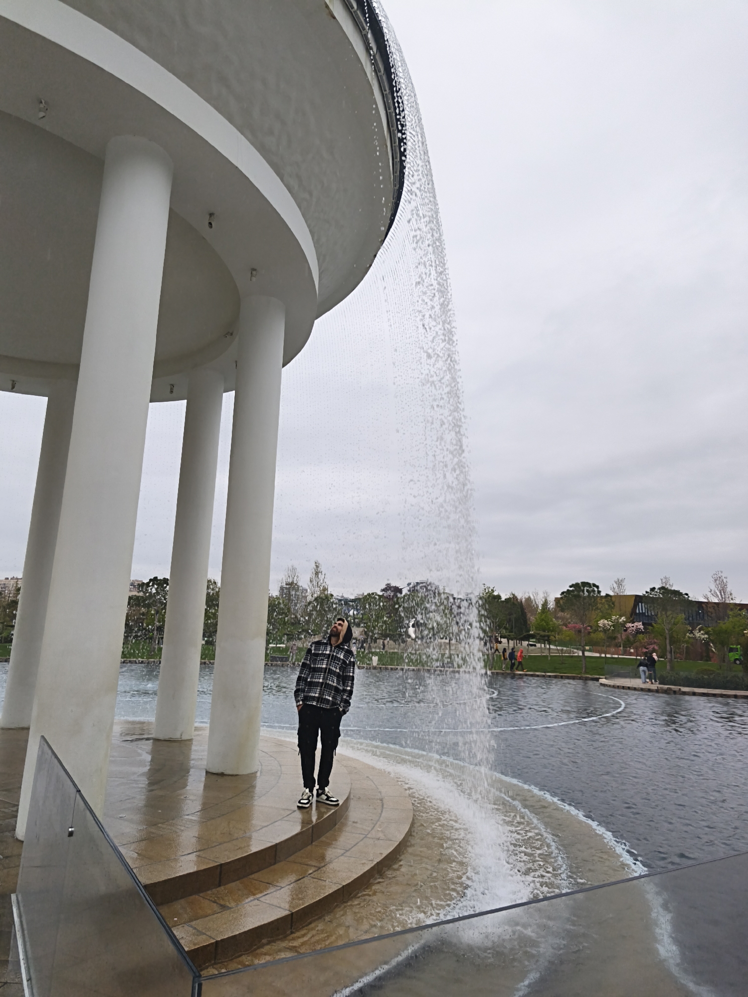 Visitor explores Krasnodar park featuring sculptures, fountains, digital displays