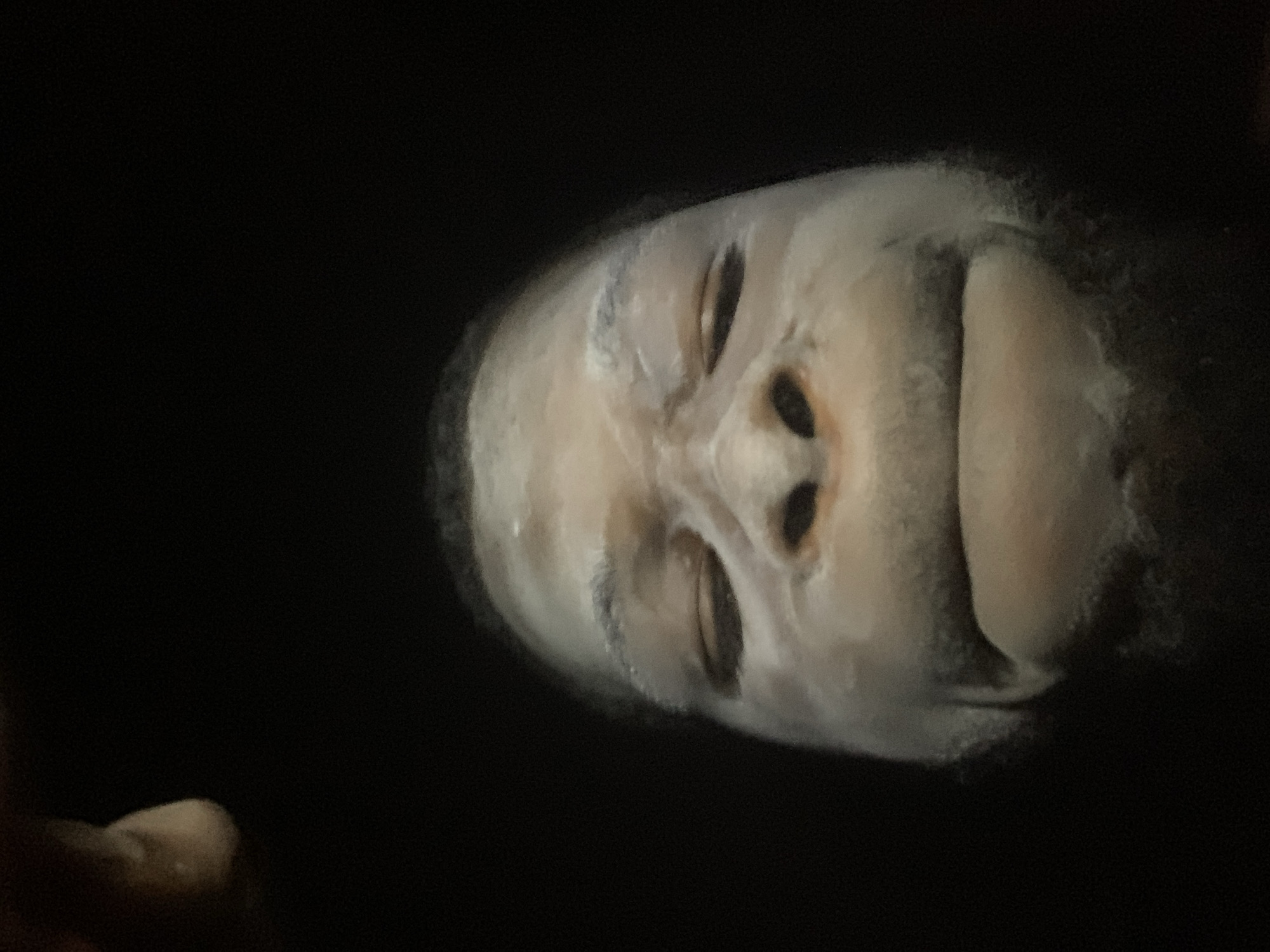 Person applies white face mask in Onitsha Nigeria