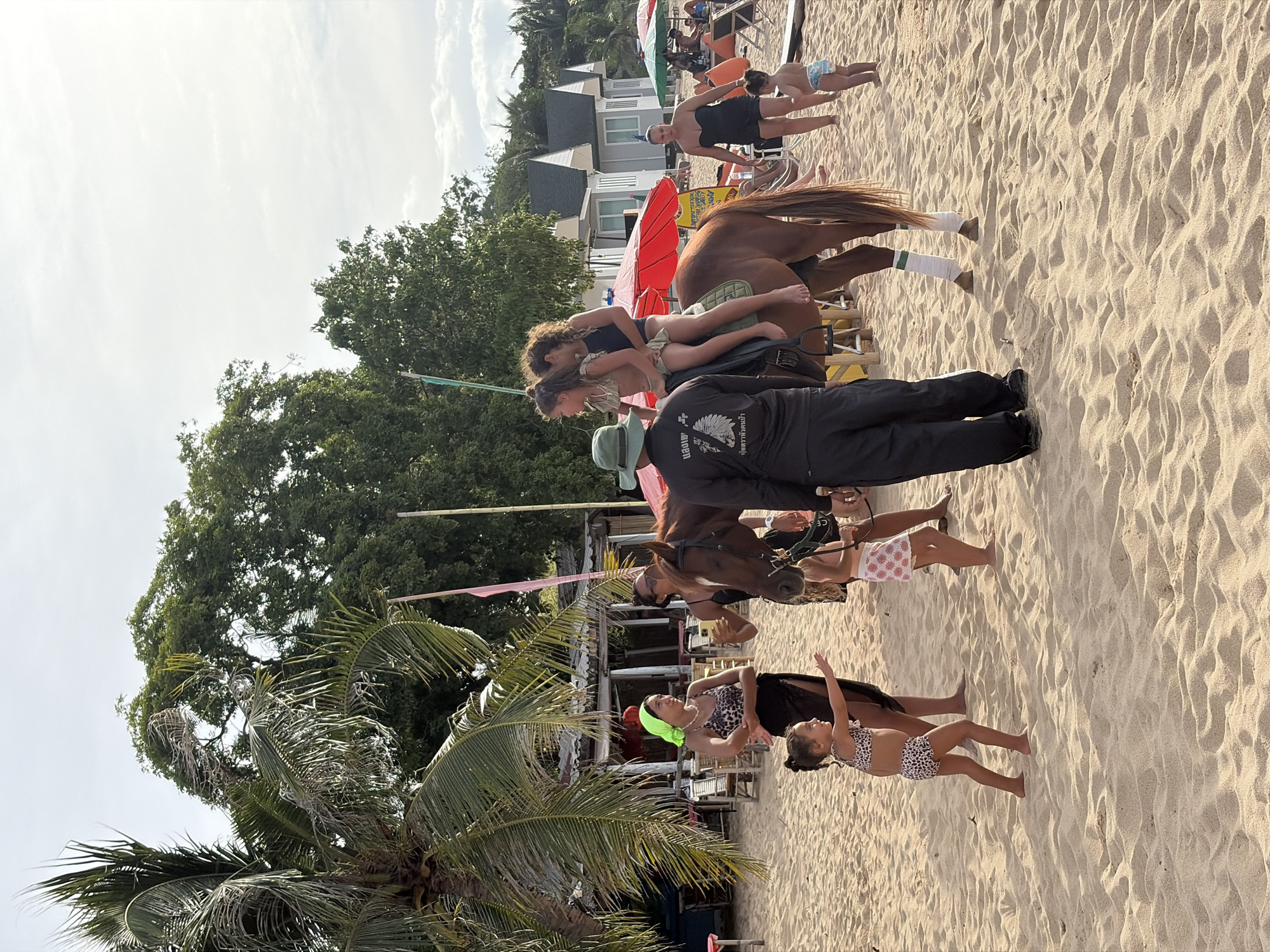 Horse rides along the Ko Samui shoreline on a sunny morning