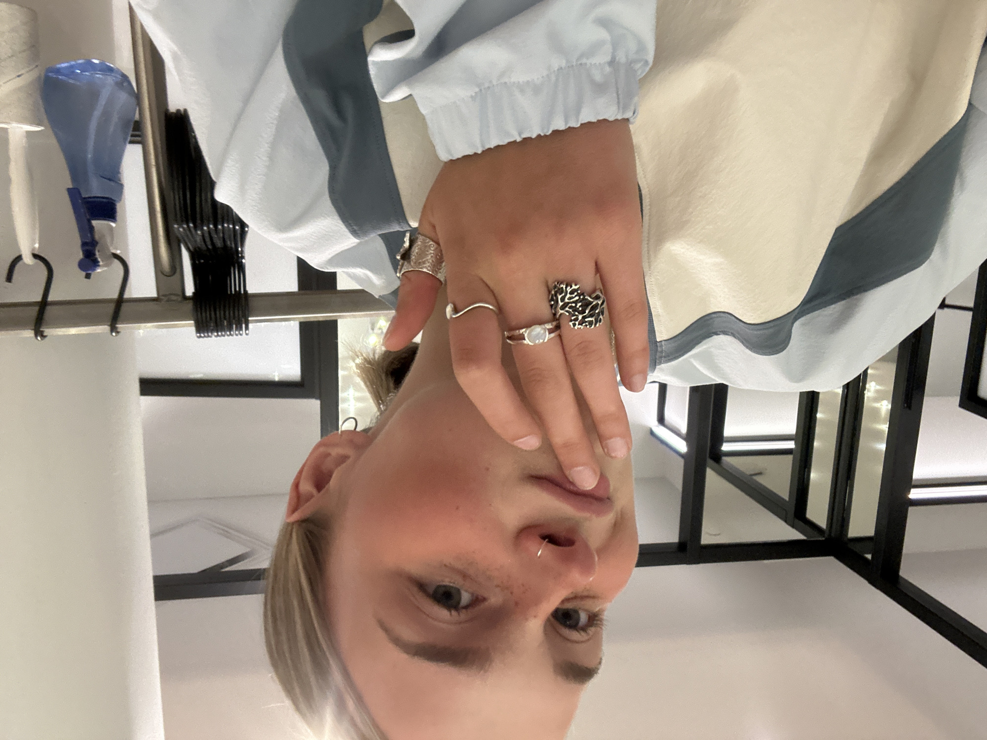 Person with piercings, rings photographed upside-down in Whistler