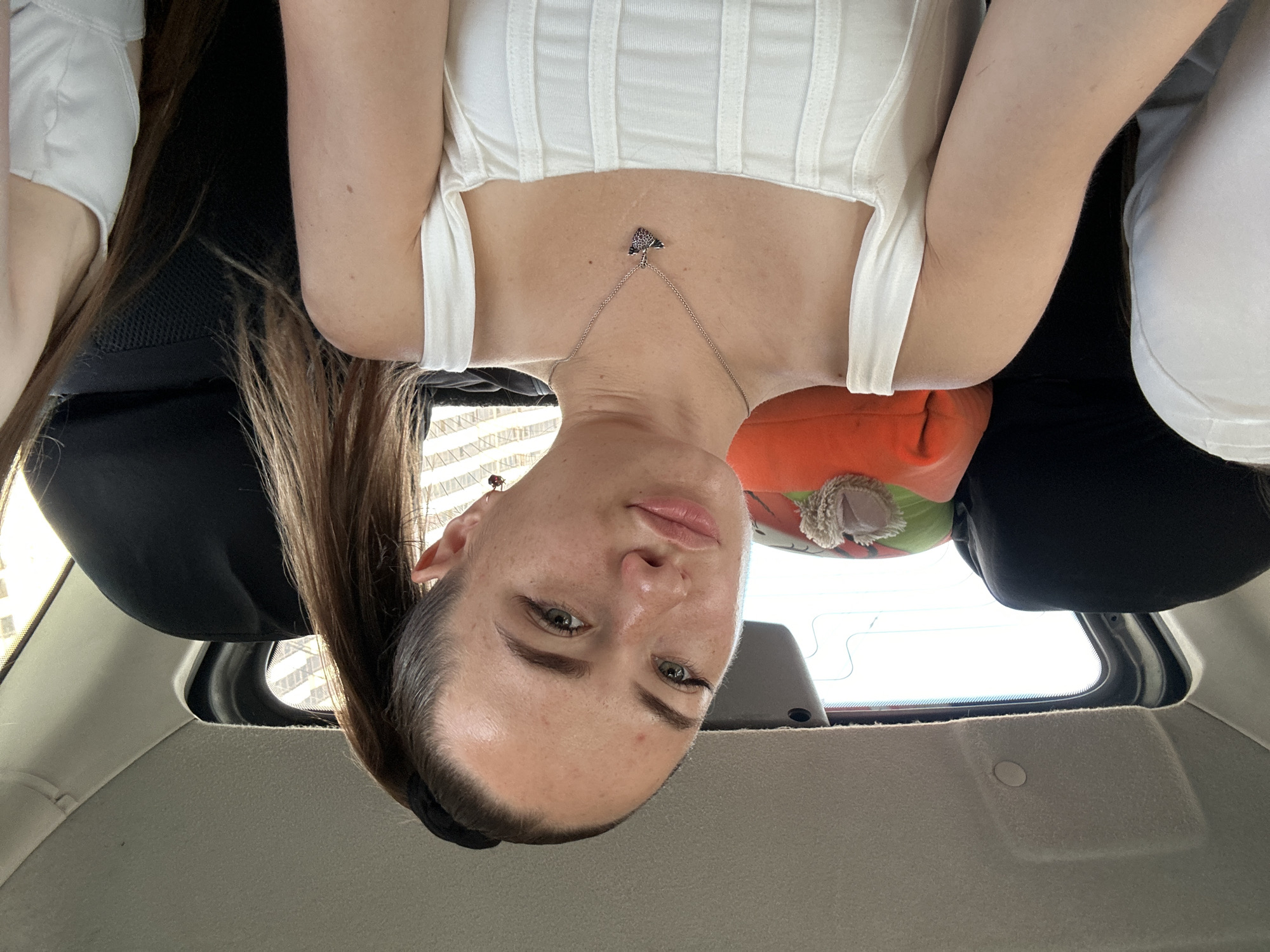 Casual backseat moment, silver necklace catching the light
