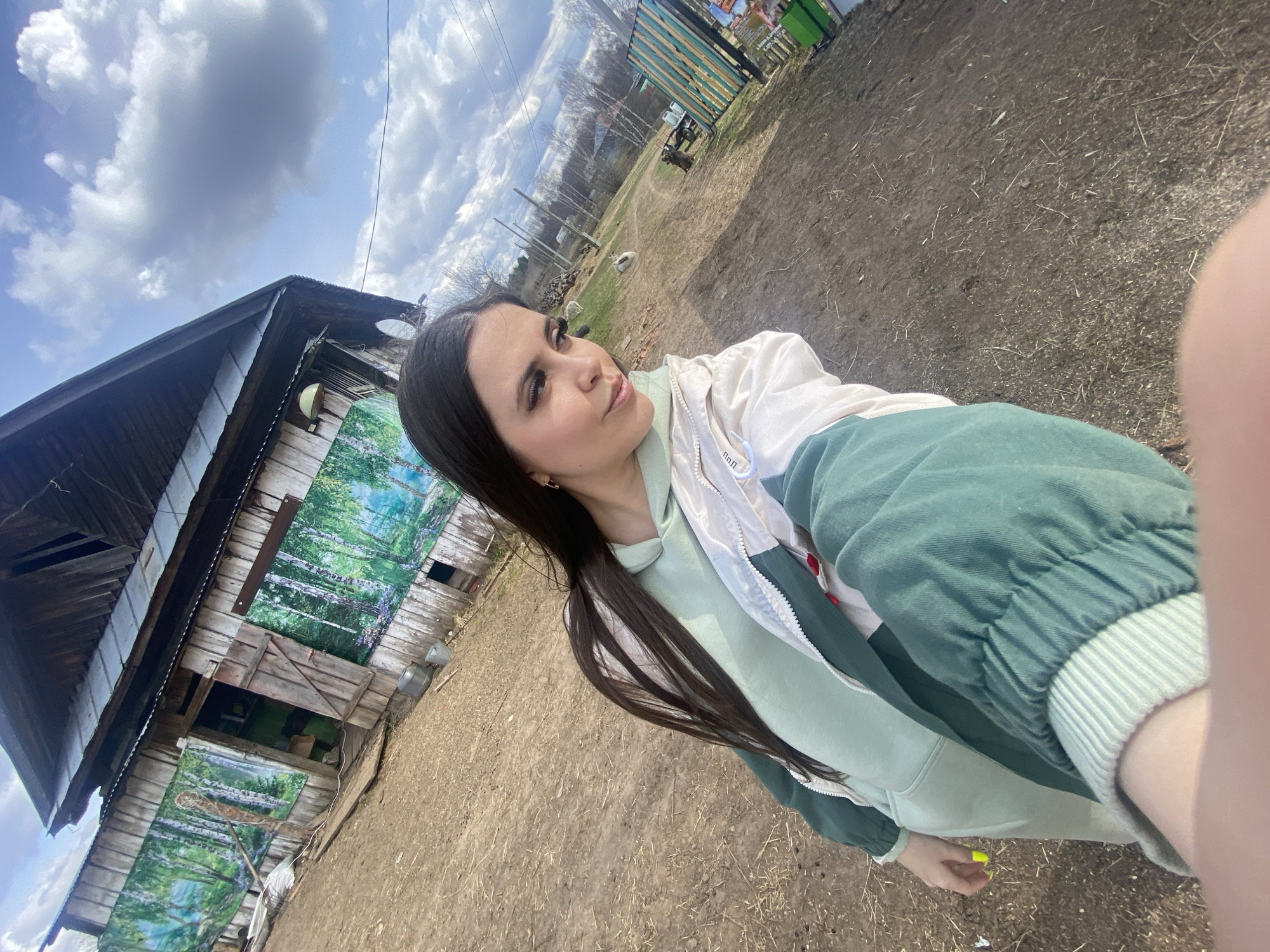 Woman documents farm visit with animals in rural Russia