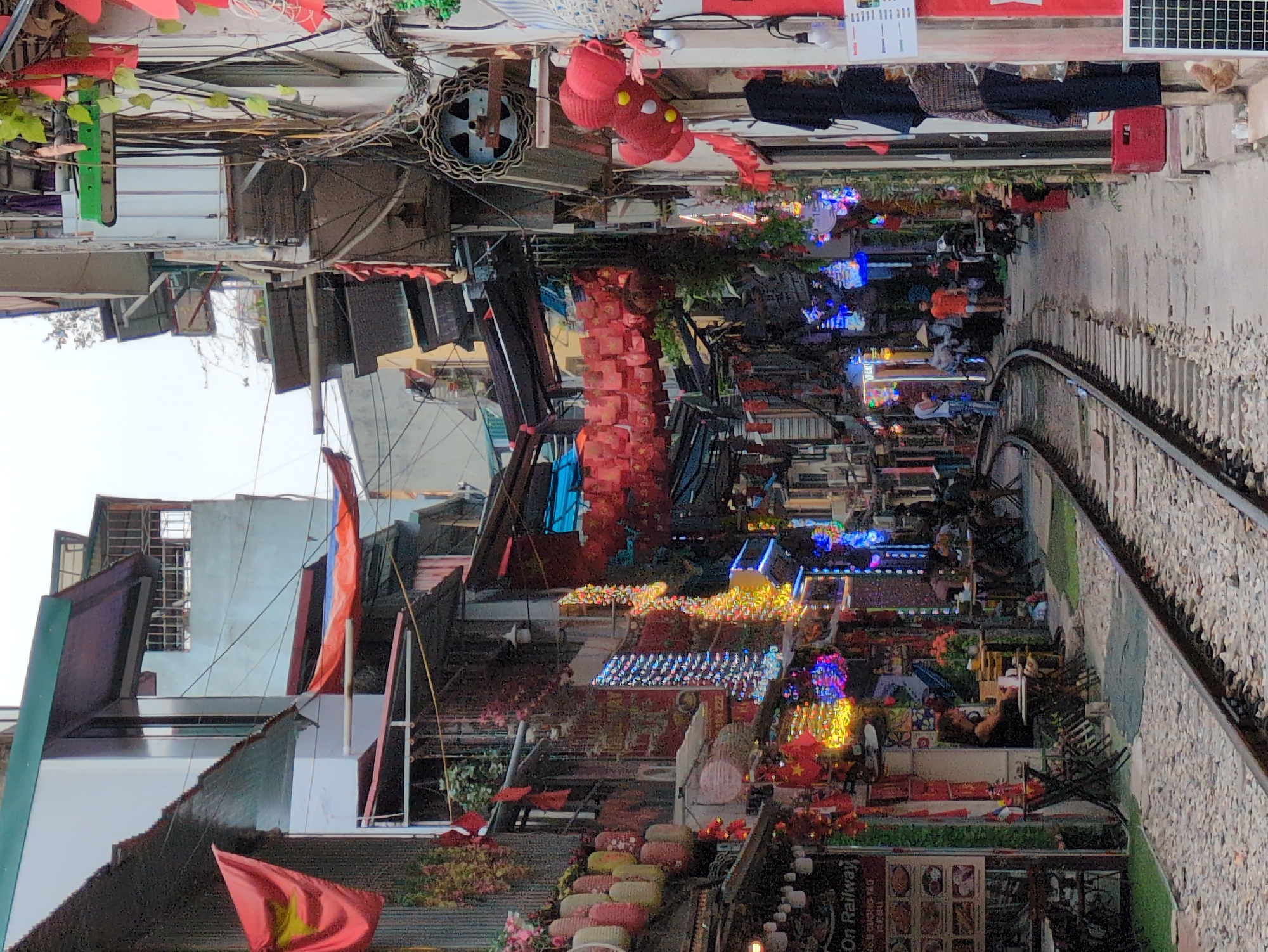 Hanoi's famous train street, tracks cutting through a busy urban corridor