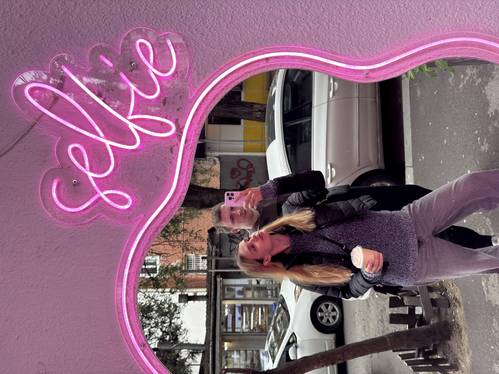 Woman takes selfies during casual walk through Tbilisi streets