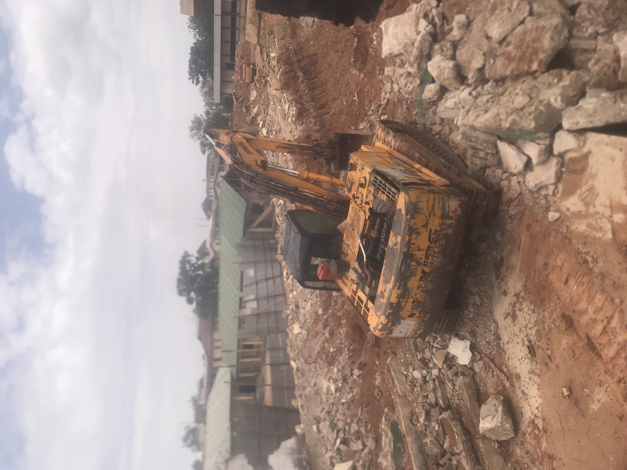 Construction work underway at Jos building site with excavator