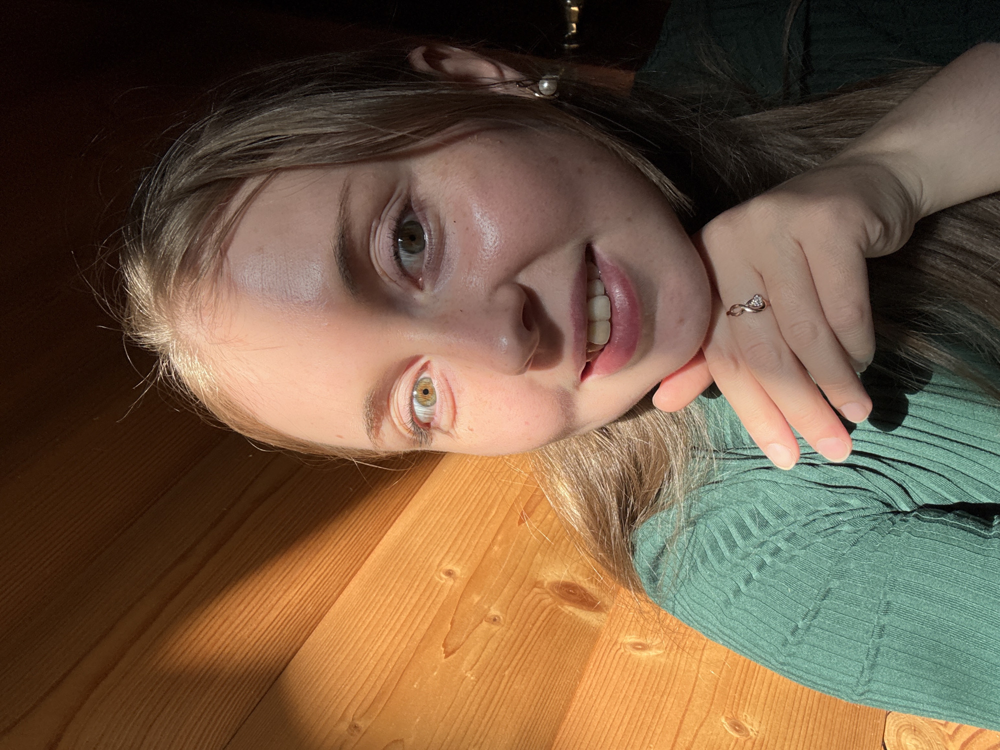 Indoor selfie session with consistent outfit and wooden backdrop