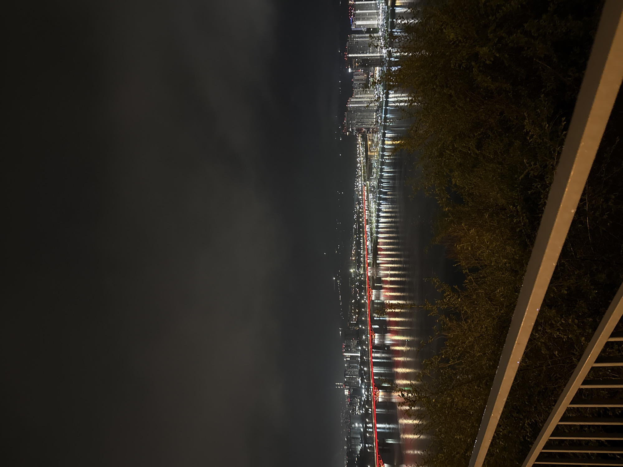 Night photography session captures illuminated Krasnoyarsk cityscape and bridge