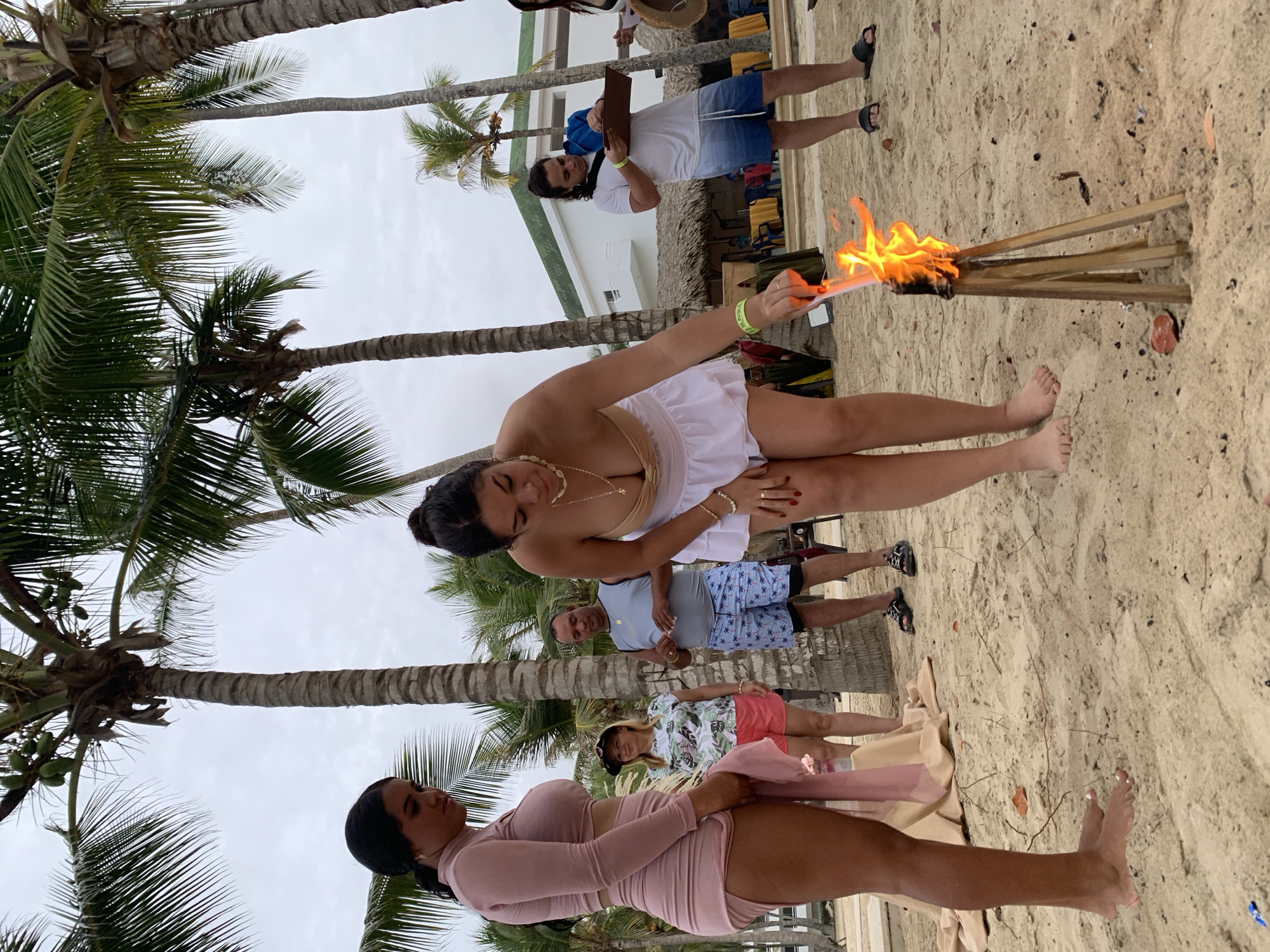Evening beach gathering with torches in El Tirano, Venezuela