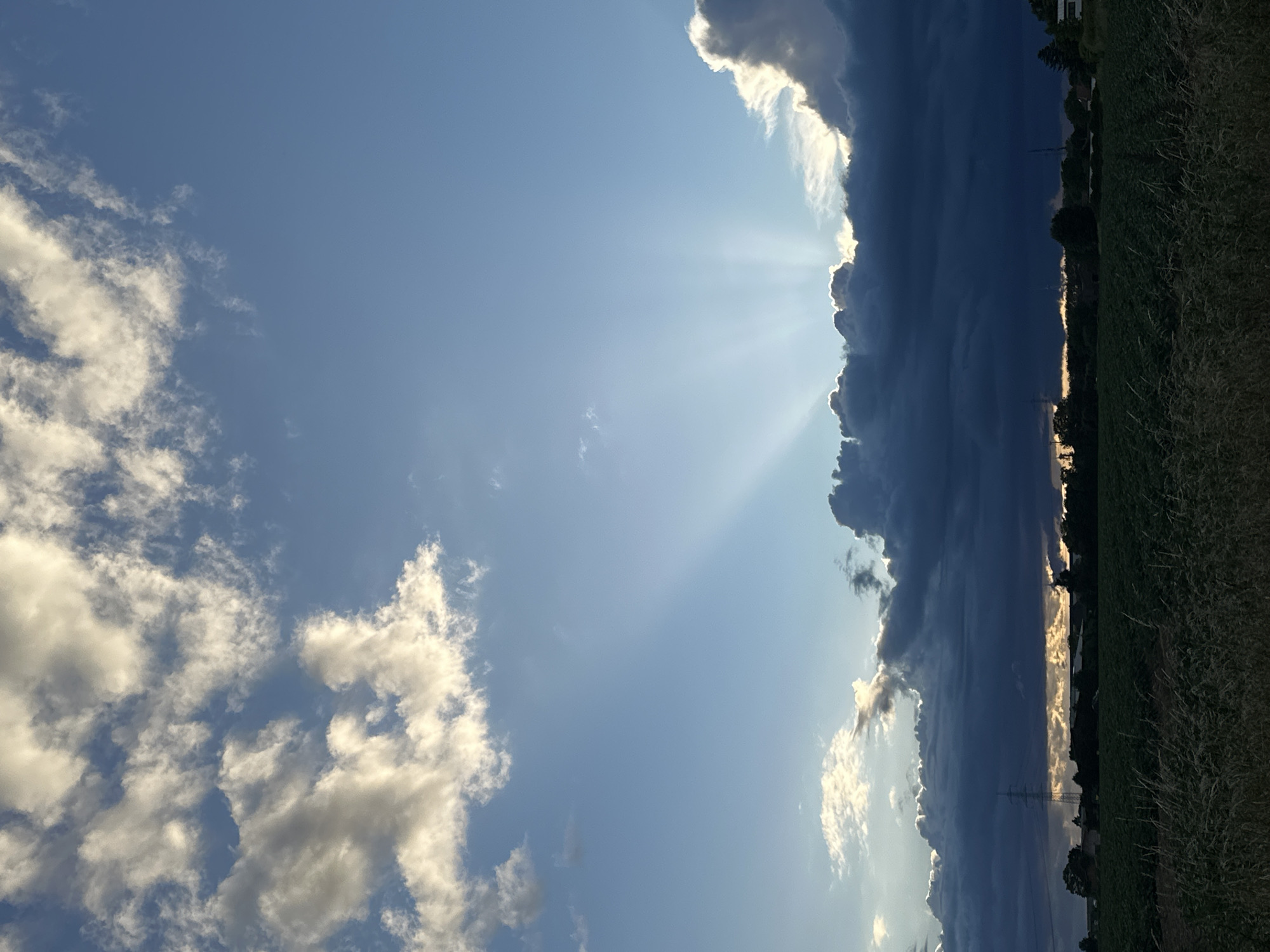 Dramatic sunbeams pierce storm clouds over rural Krefeld Germany