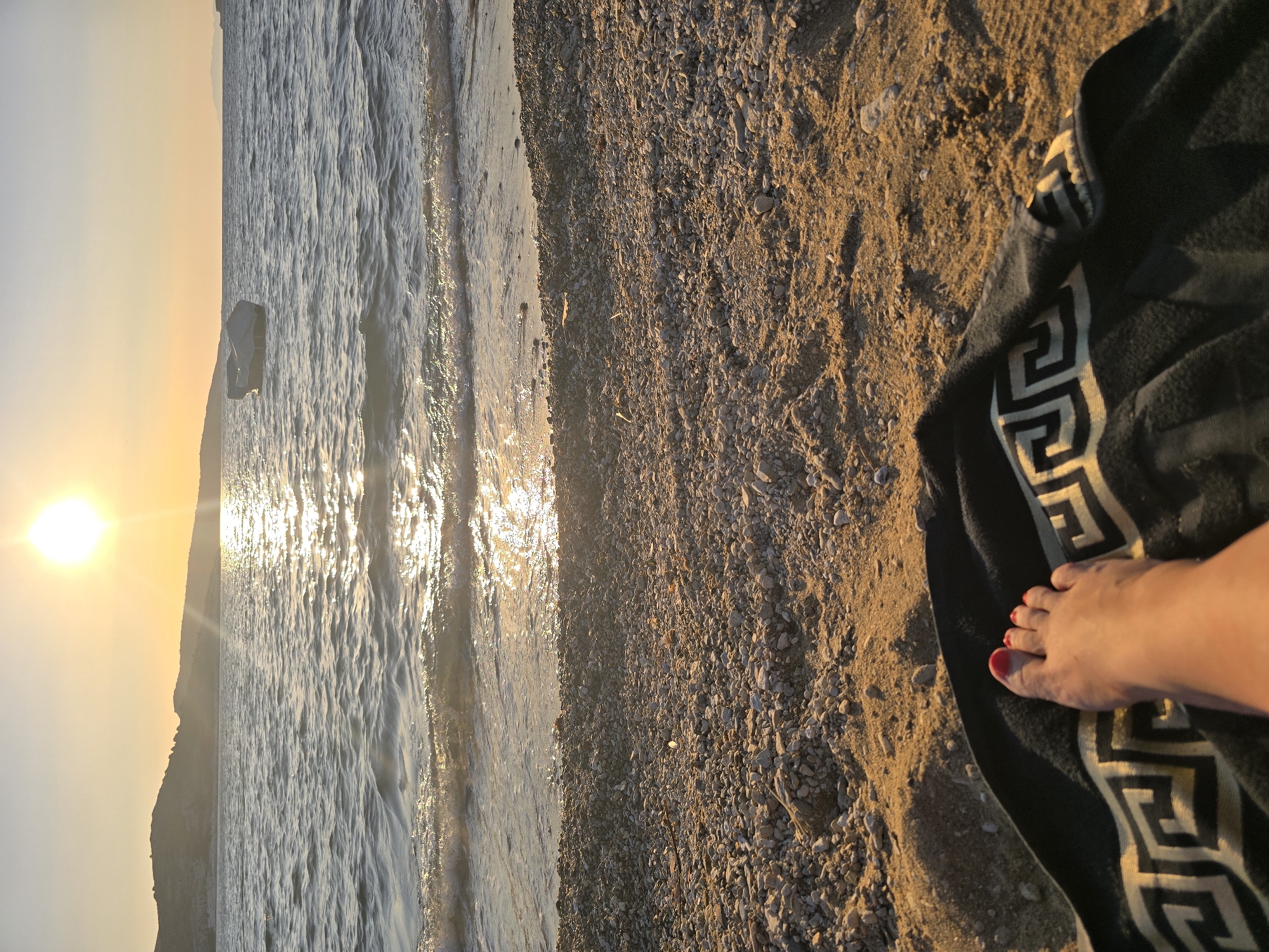 Sunset wind-down on a pebbly Aegean beach in Foça