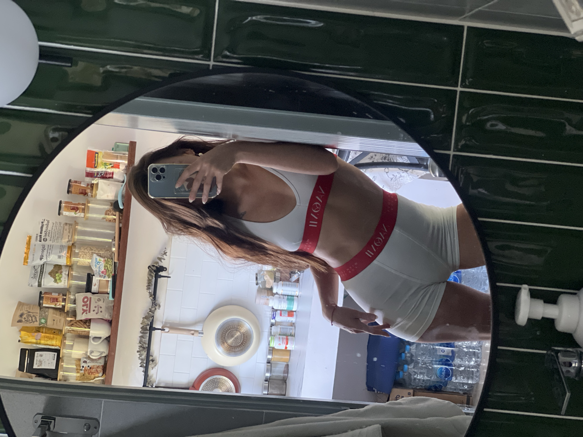 Woman in branded athletic wear takes mirror selfies