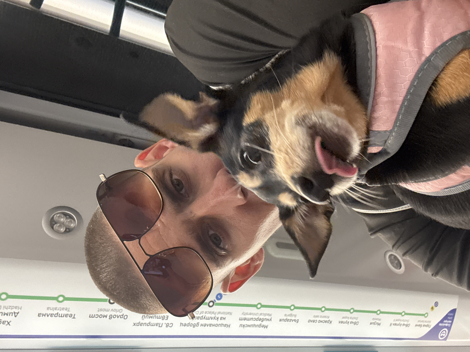 Man and dog in pink harness ride Sofia Metro