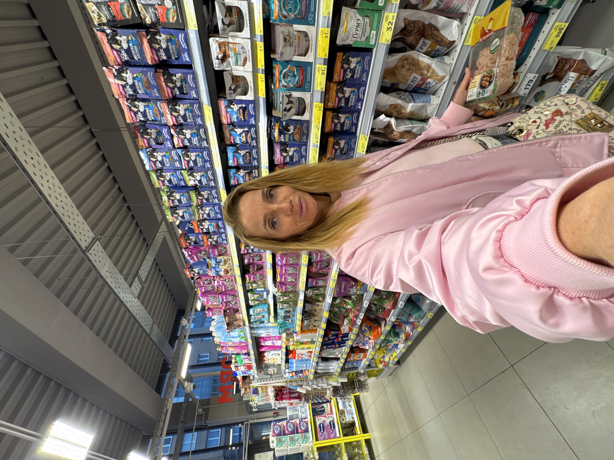 Woman completes routine grocery shopping at Saint Petersburg Magnit store