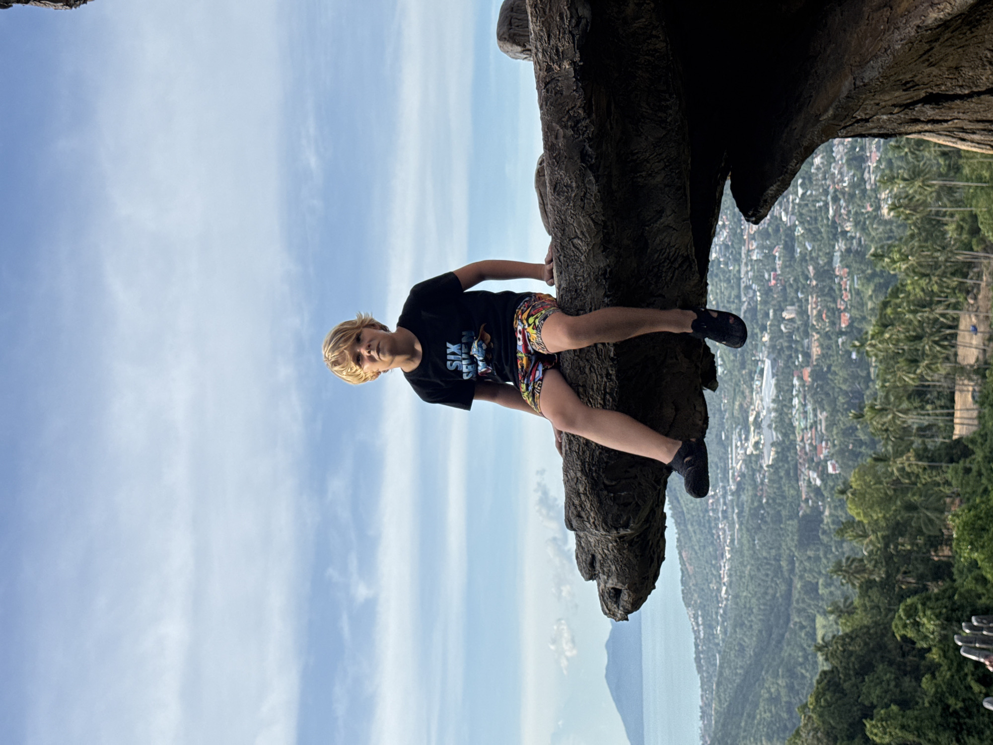 Coastal hilltop viewpoint with hand sculpture and ocean views