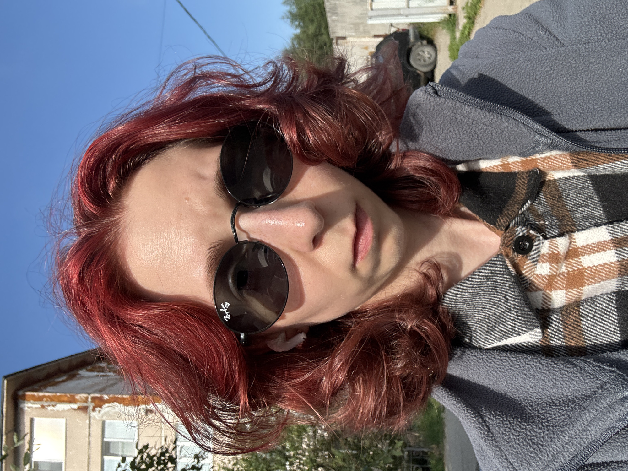 Red-haired selfie series outside a residential building