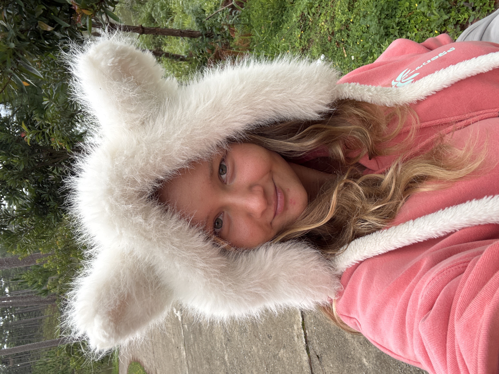 Rabbit-ear hoodie selfie in a Vietnamese park setting