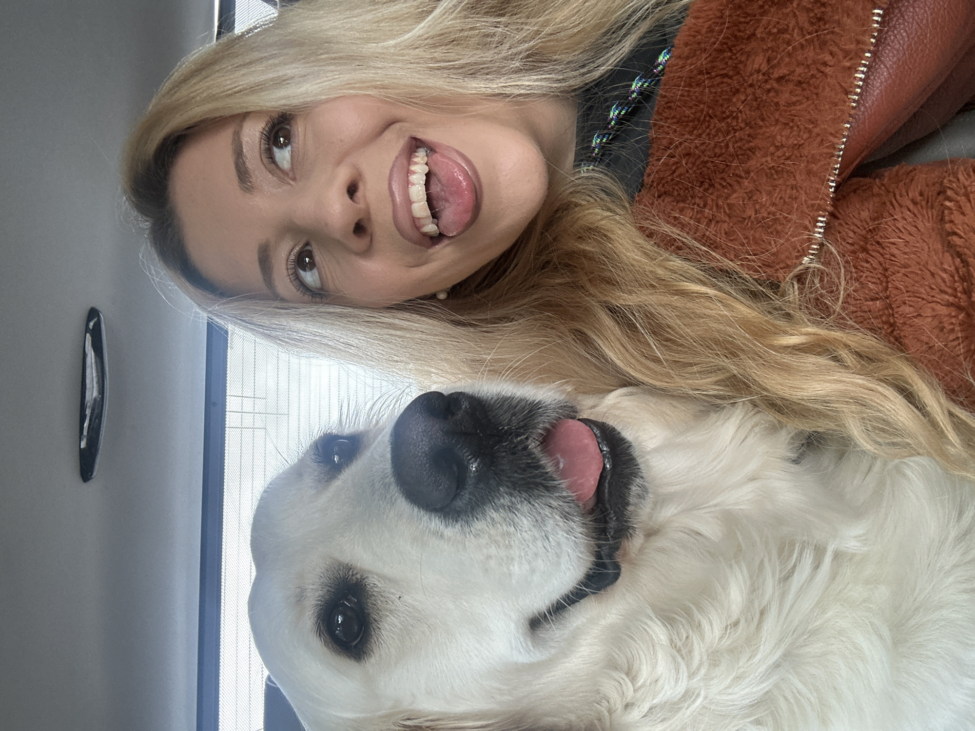 Woman takes selfies with white dog in London