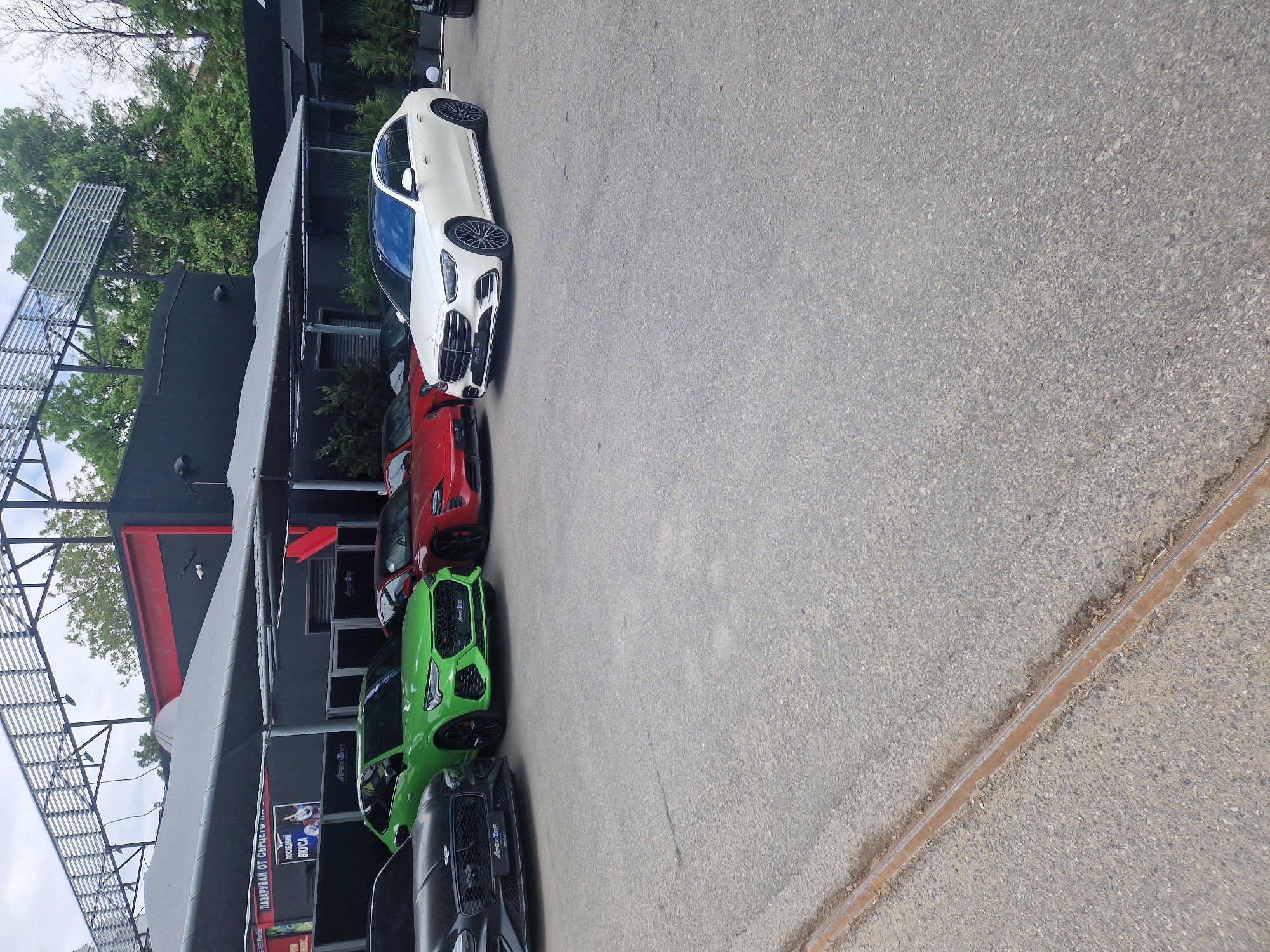 Luxury cars observed parked in urban commercial area