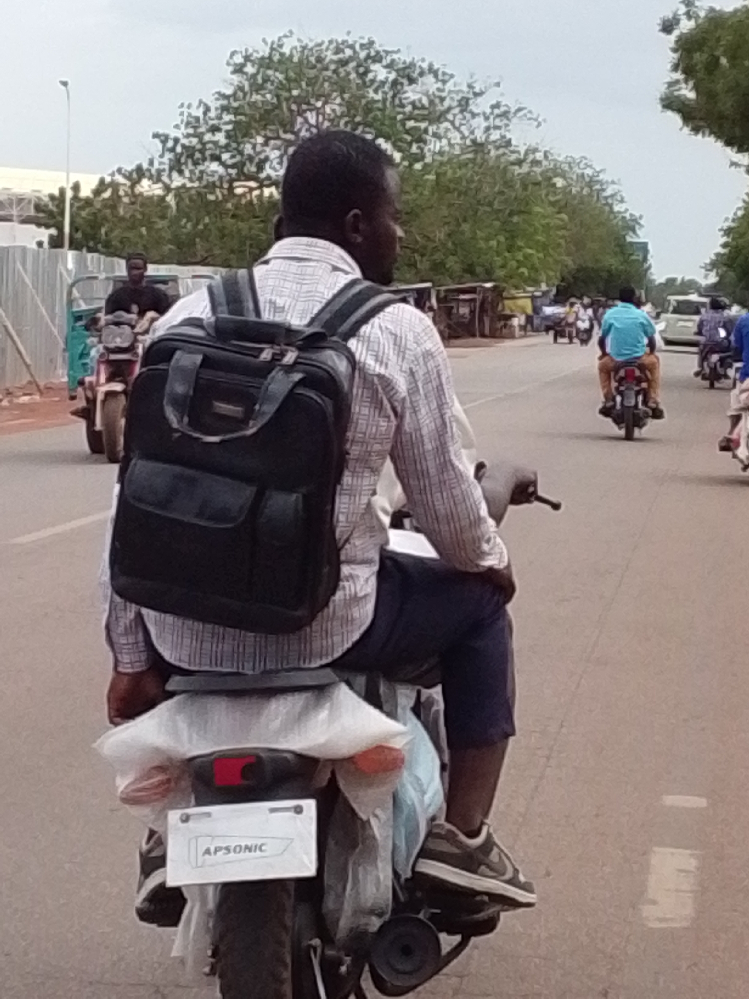 Motorcyclist travels through Tamale streets in northern Ghana