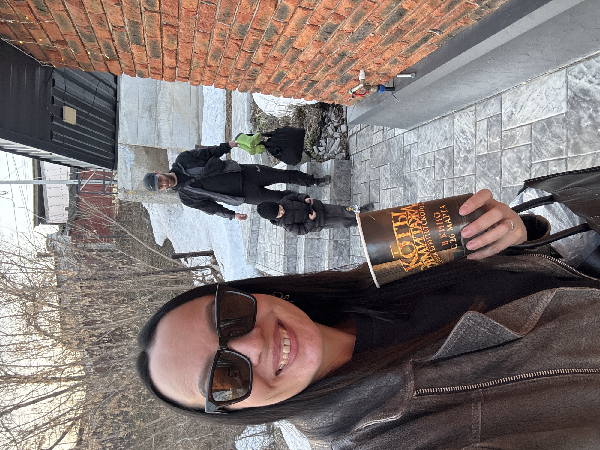 Woman takes selfies with movie promo cup in Chaikovsky
