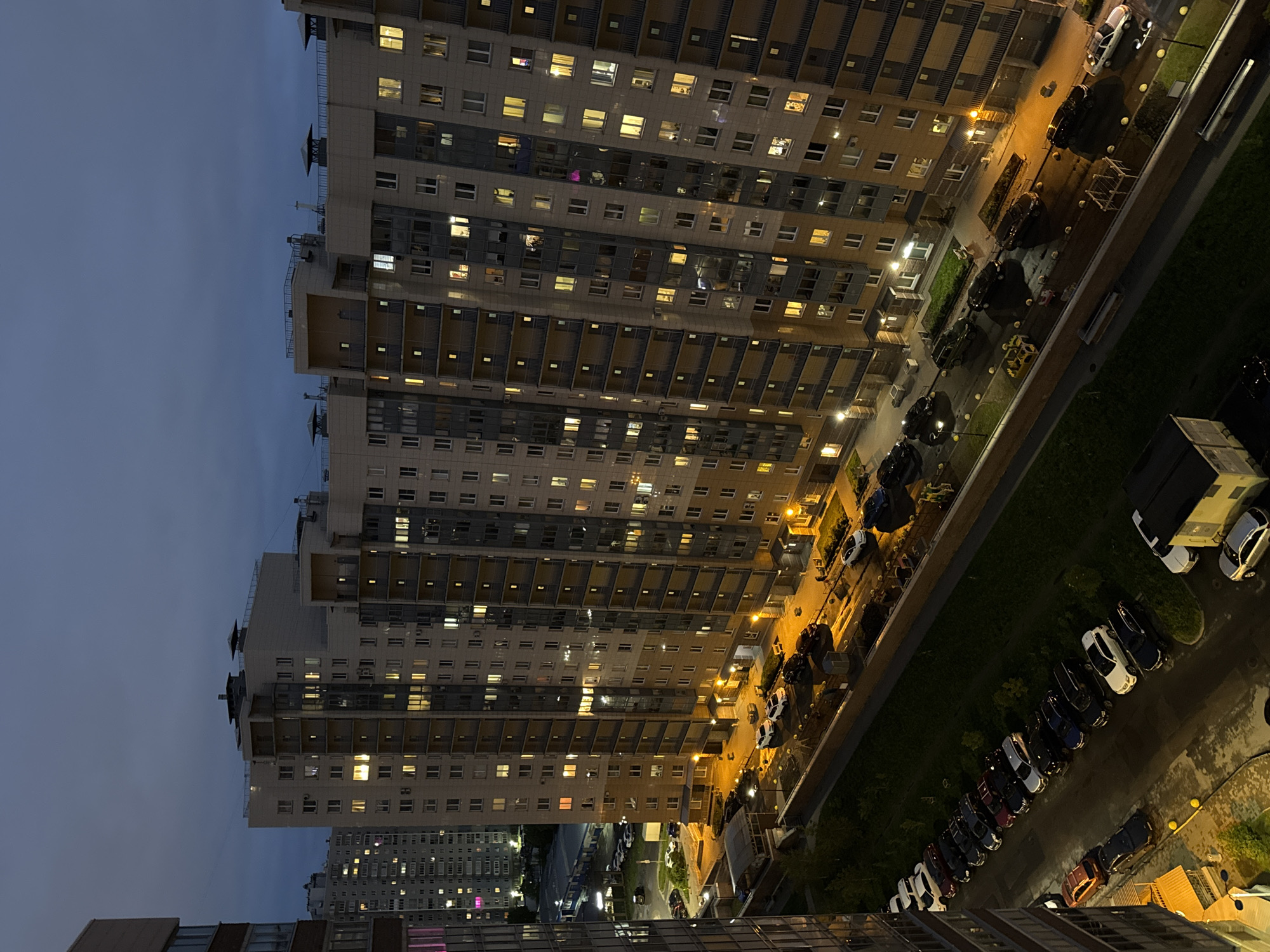Evening lights illuminate Russian apartment buildings at dusk