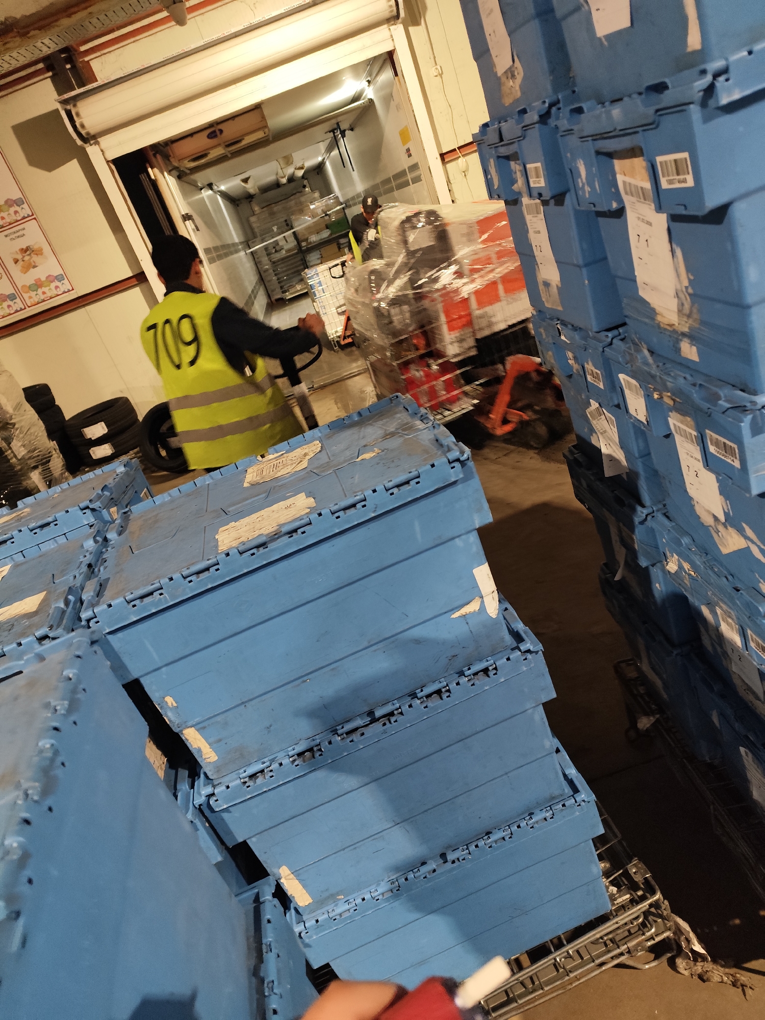 Worker in safety vest moves materials in Bulgarian warehouse