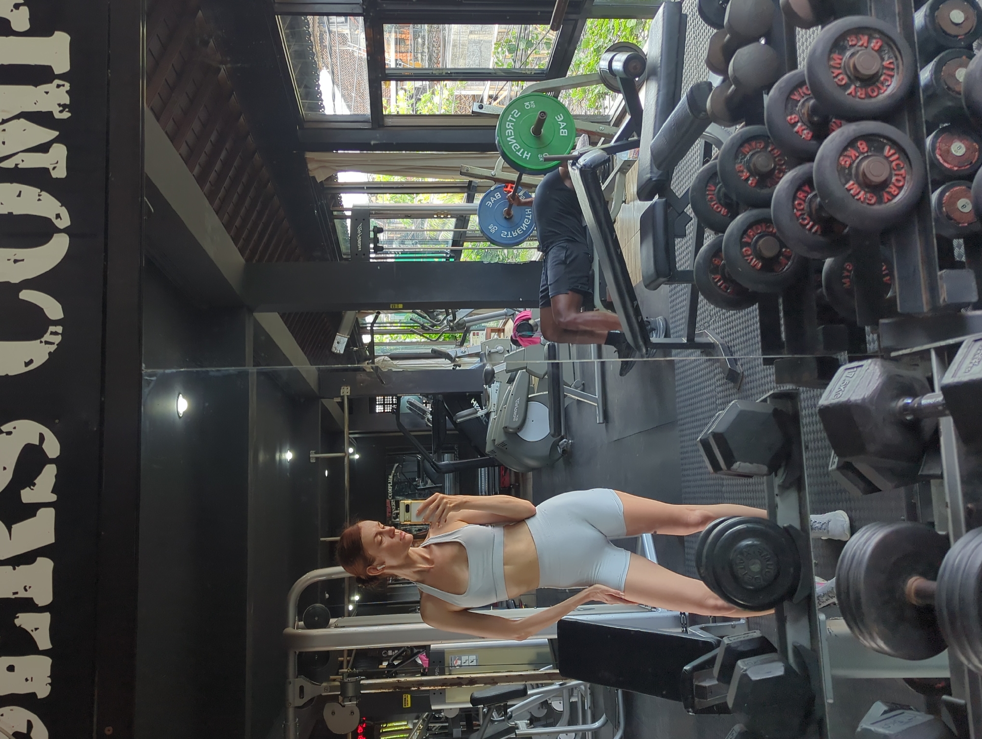 Woman exercises at gym in Mengwi, Indonesia early morning