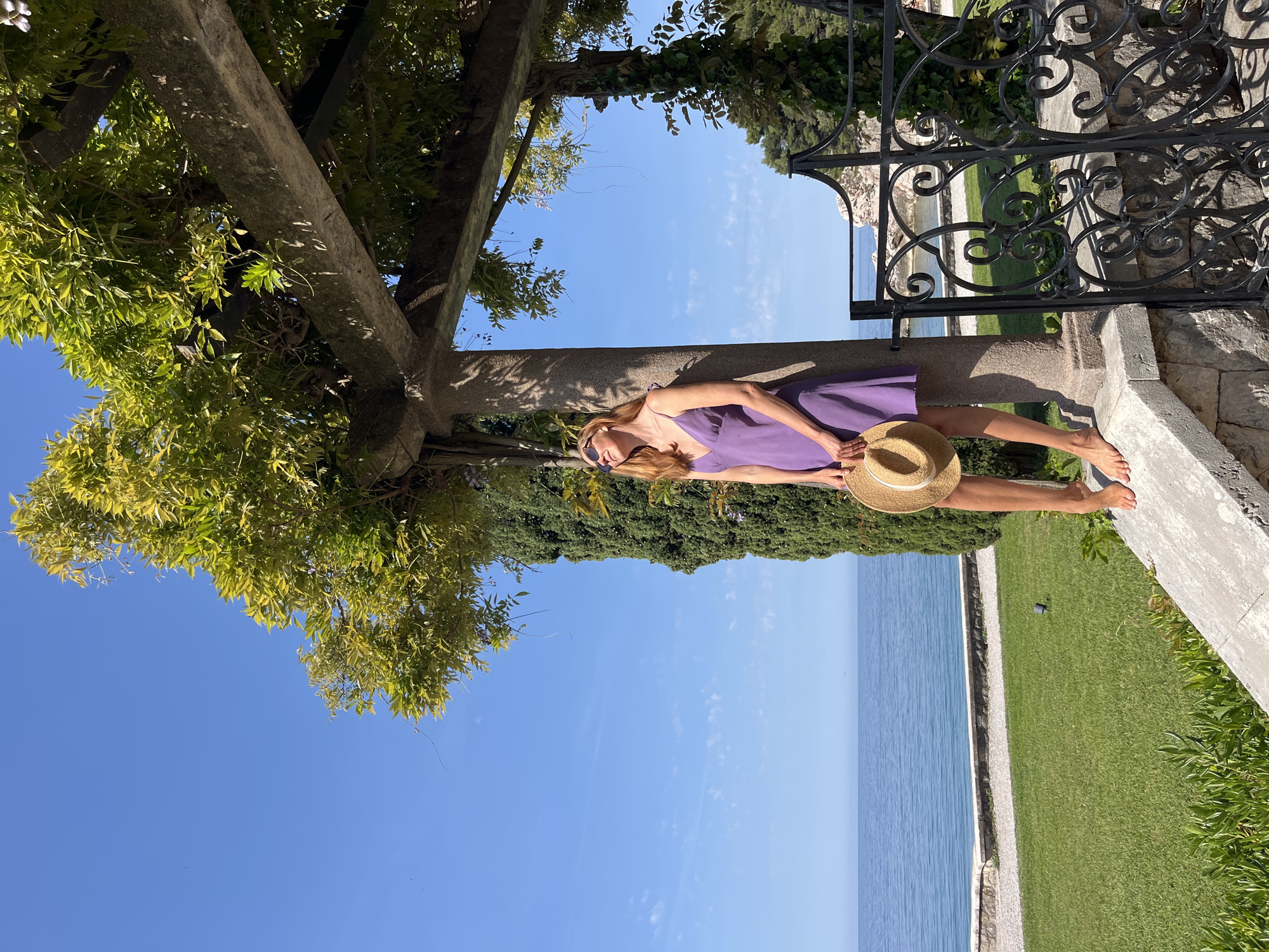 Tourist relaxes in coastal Sveti Stefan, Montenegro