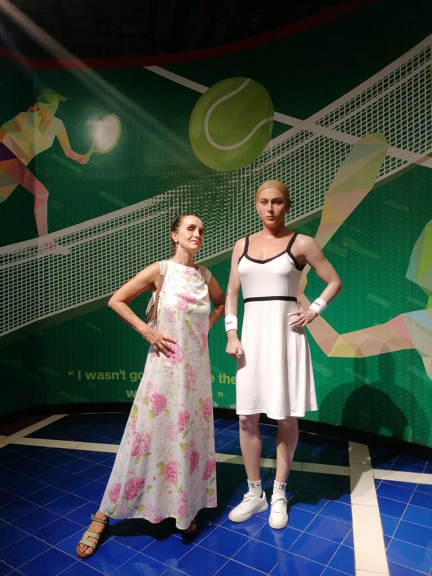 Museum visitor poses with royal wax figures