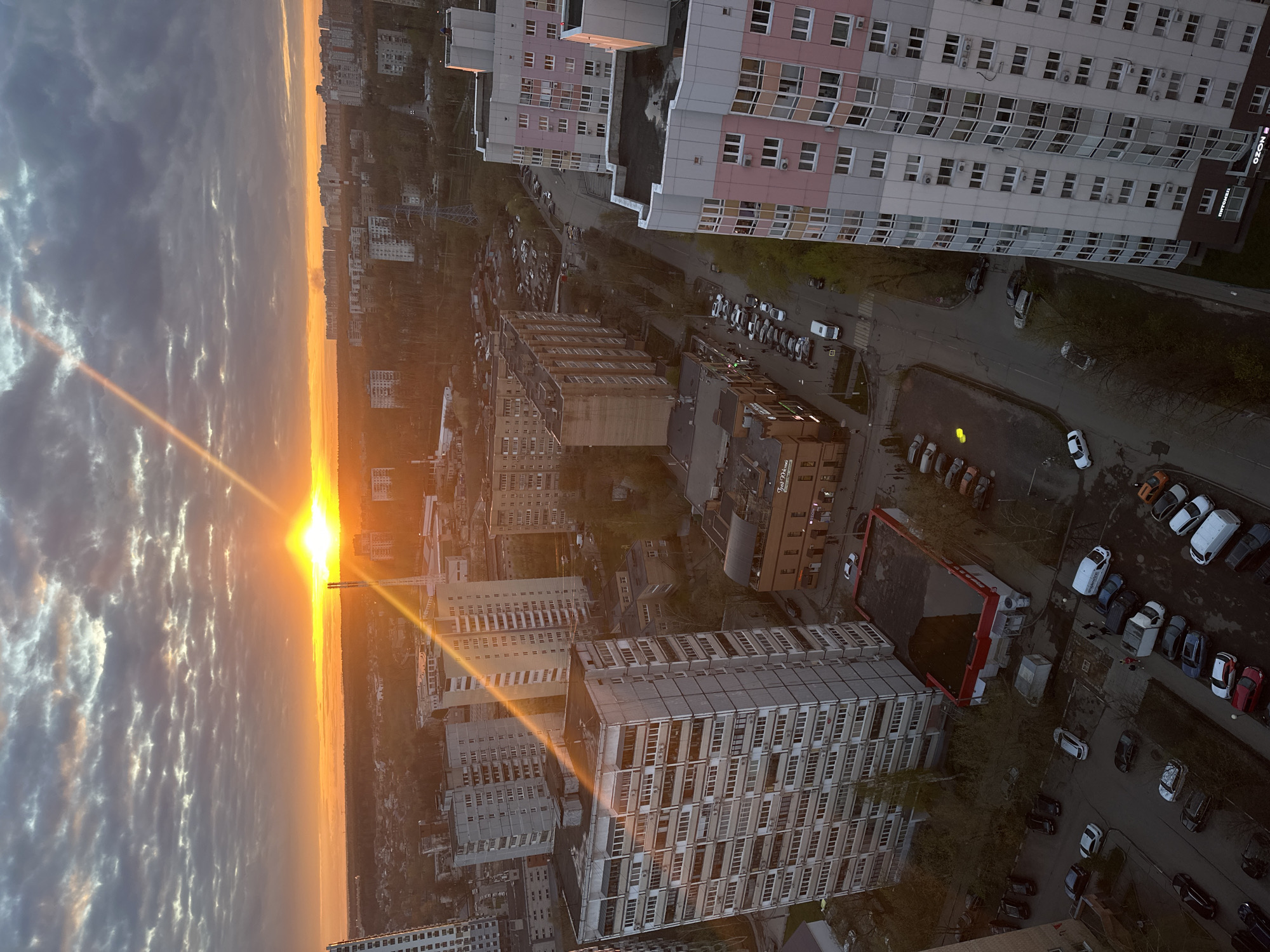Sunrise observed over Khimki cityscape with dense clouds