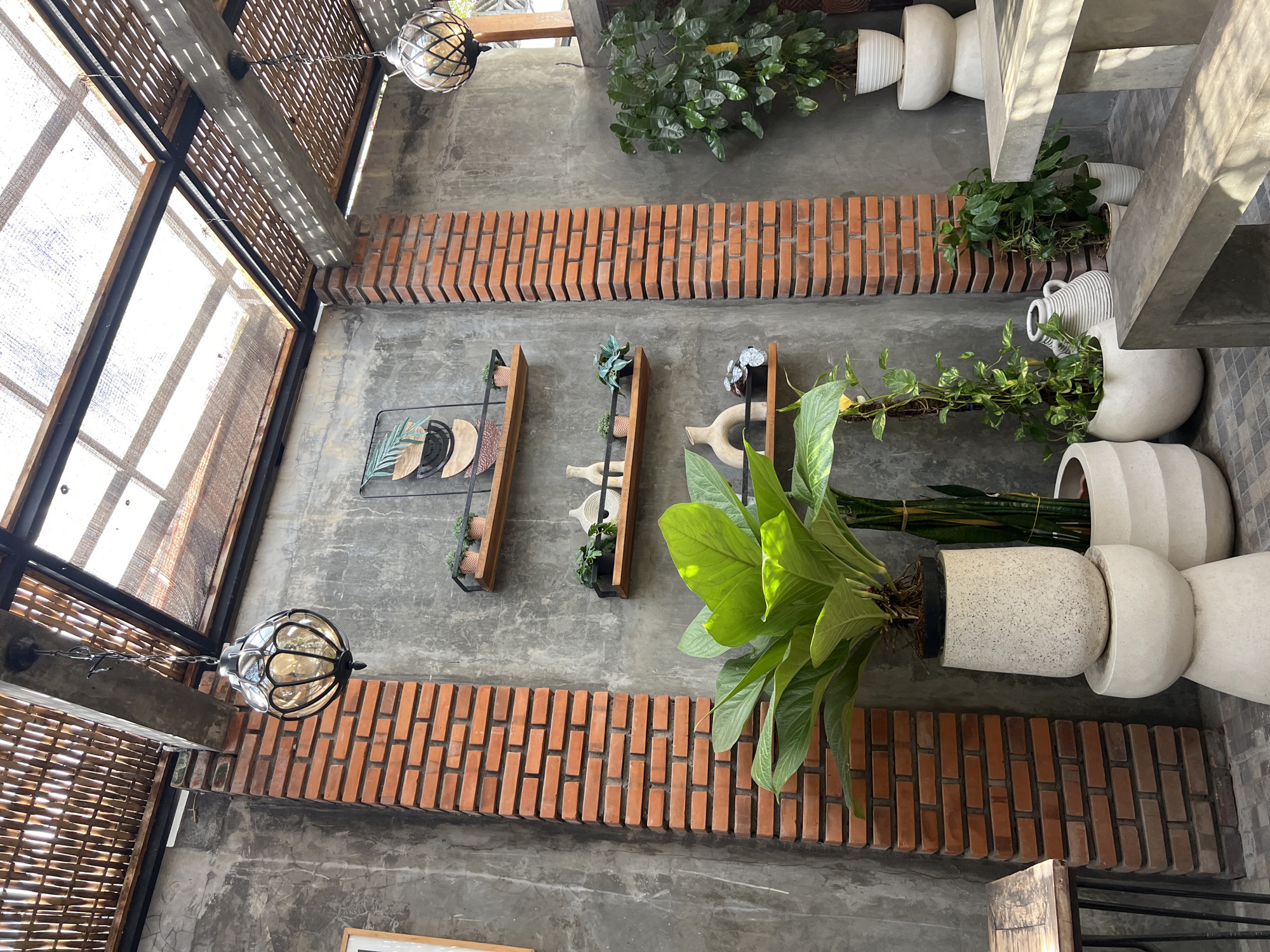 Inside and outside a rustic-modern café in North Kuta