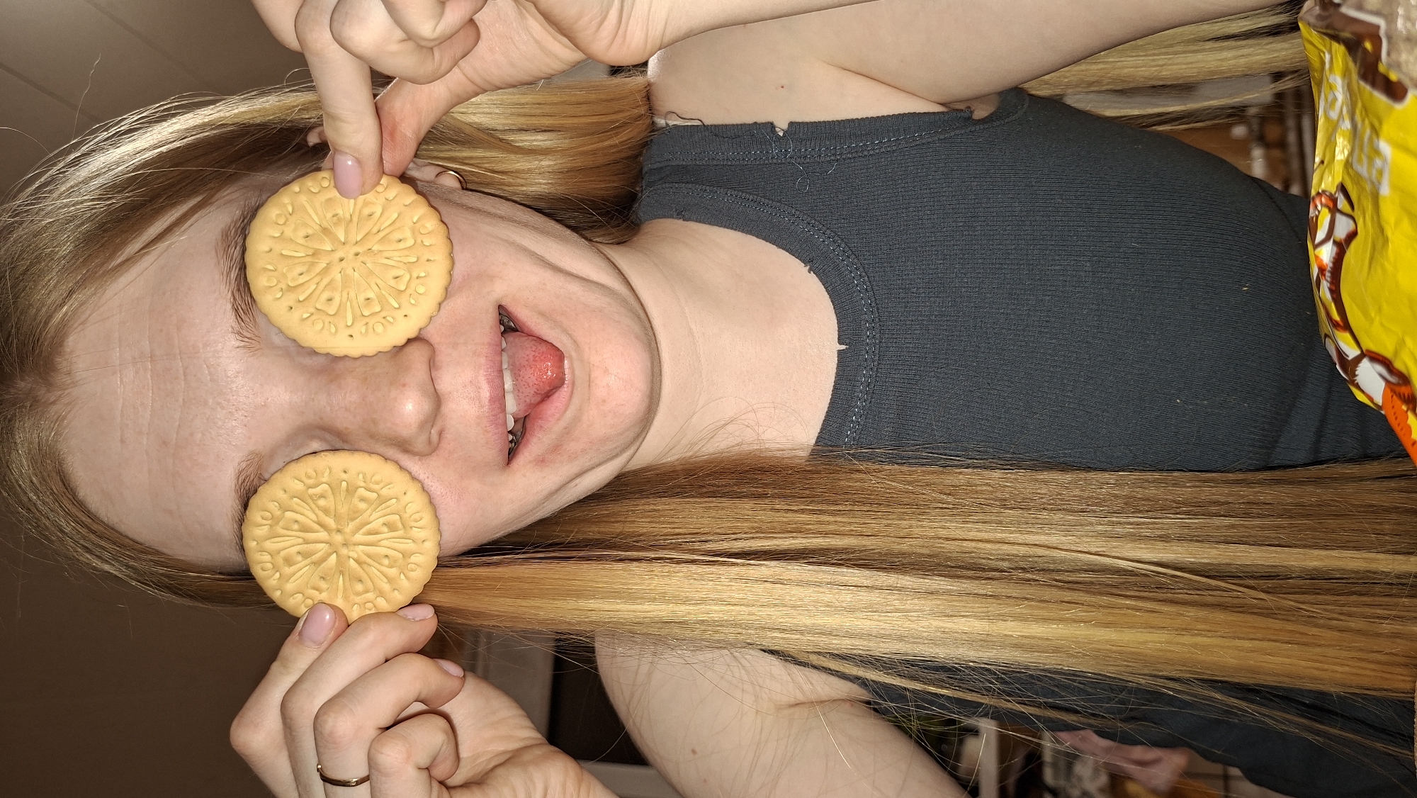 Woman poses playfully with cookies and fairy lights in Russia
