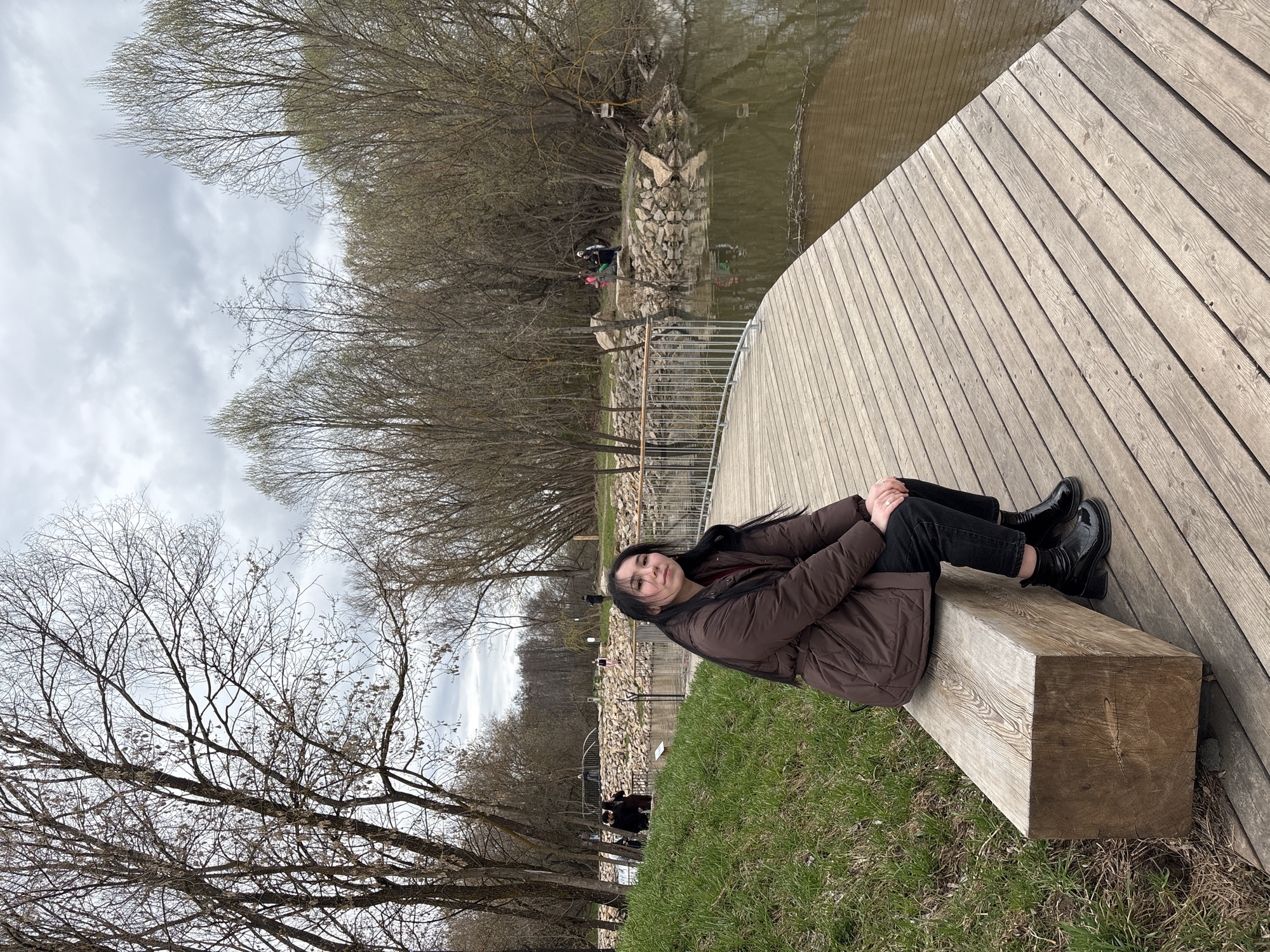 Young woman visits waterfall park in Kazan during spring