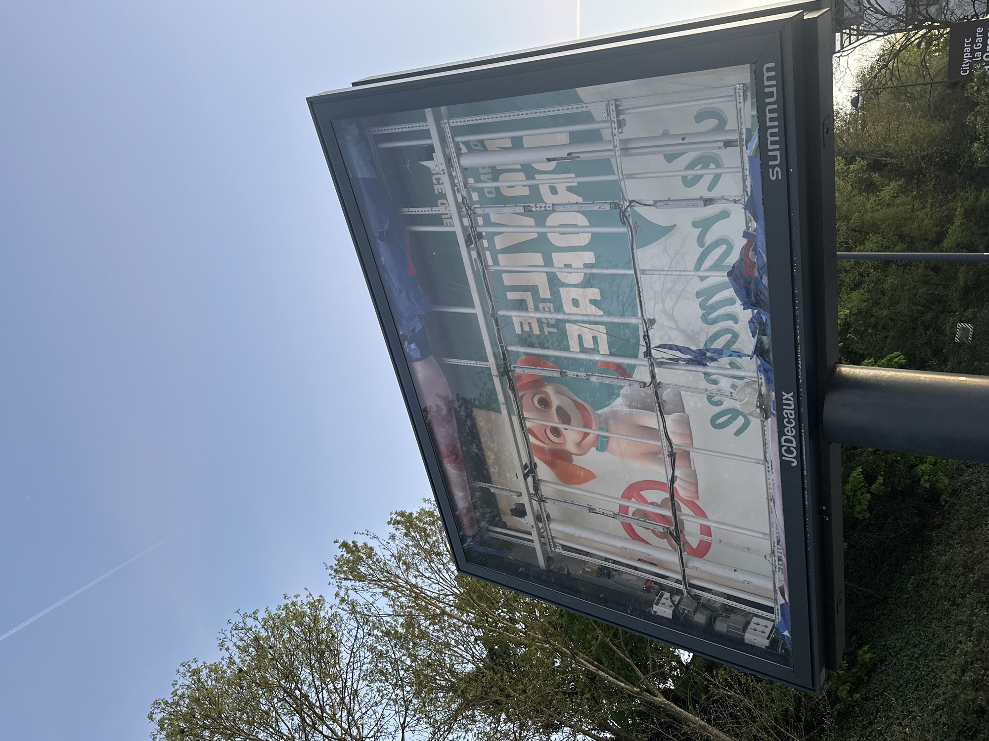 Torn billboard spotted near Orsay train station