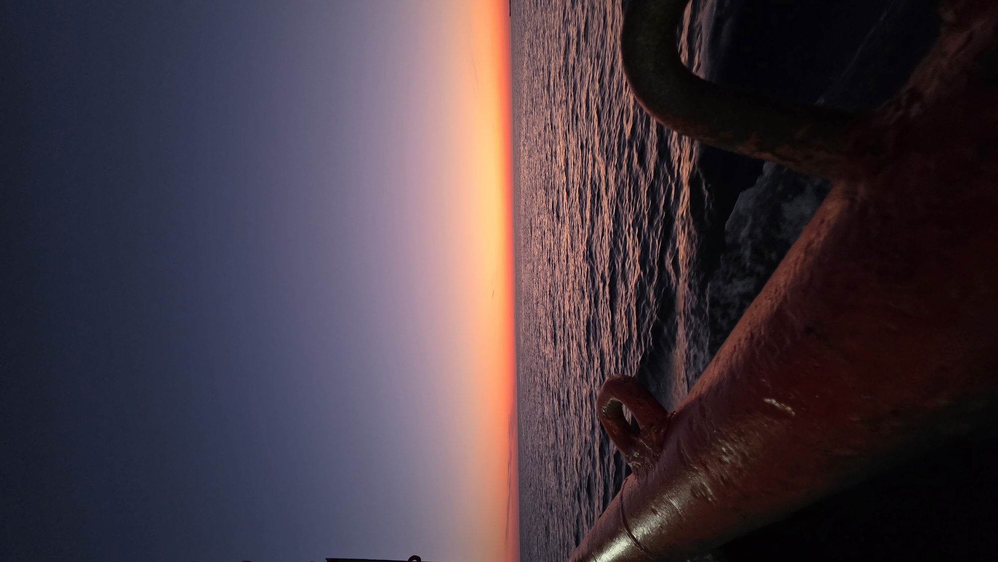 Orange sunset observed from boat off Greek coast