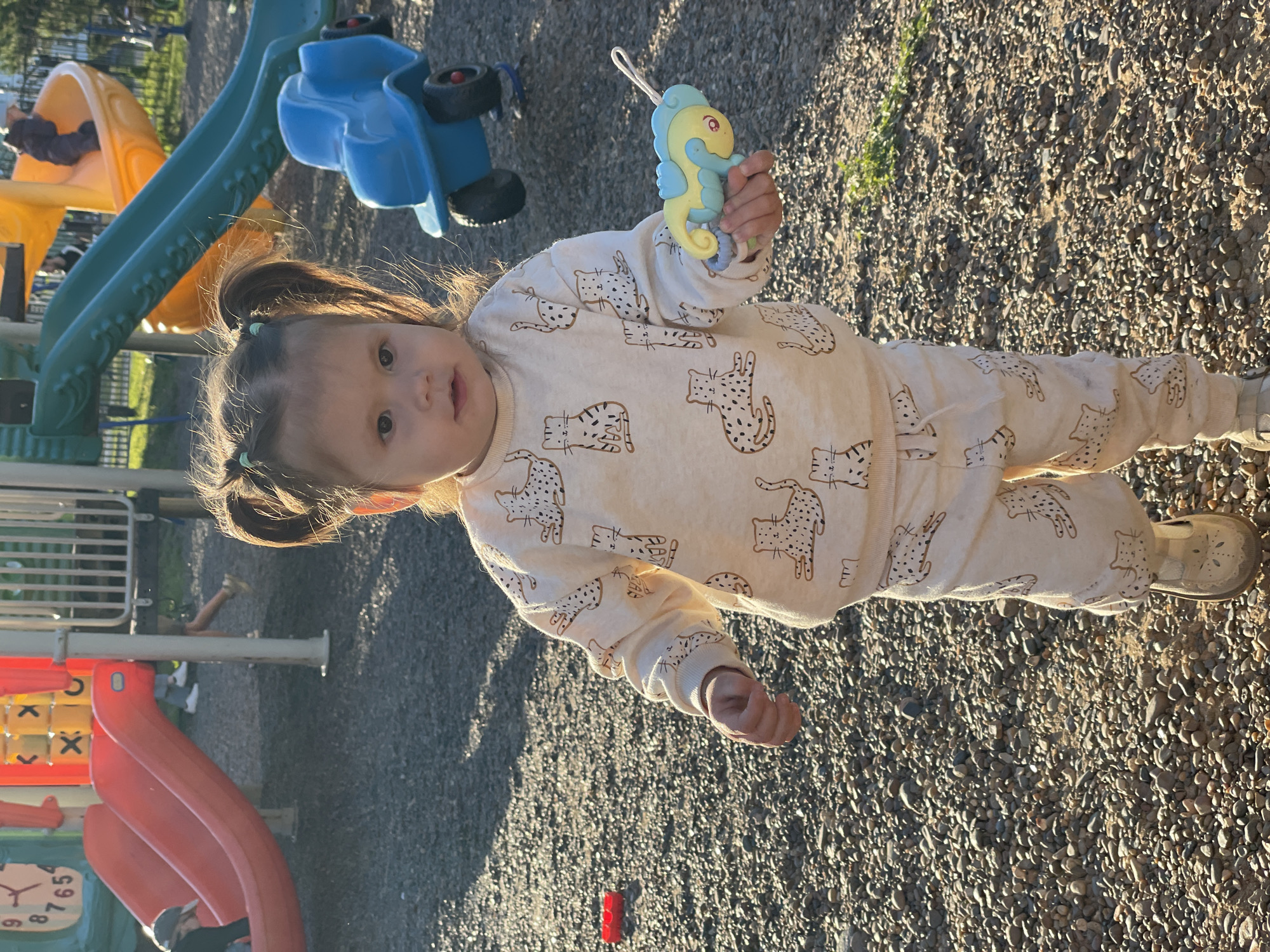 Family enjoys sunny afternoon at Izhevsk playground near cathedral
