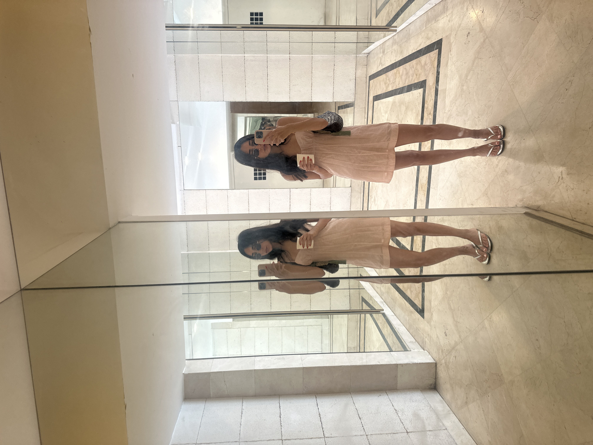 Selfies in a mirrored Tel Aviv lobby on a sunny morning
