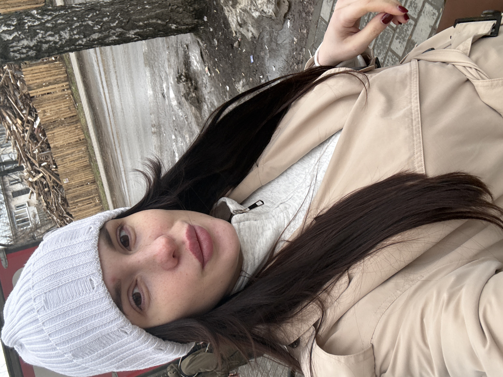Person in layered winter clothing photographed in selfie-style shot