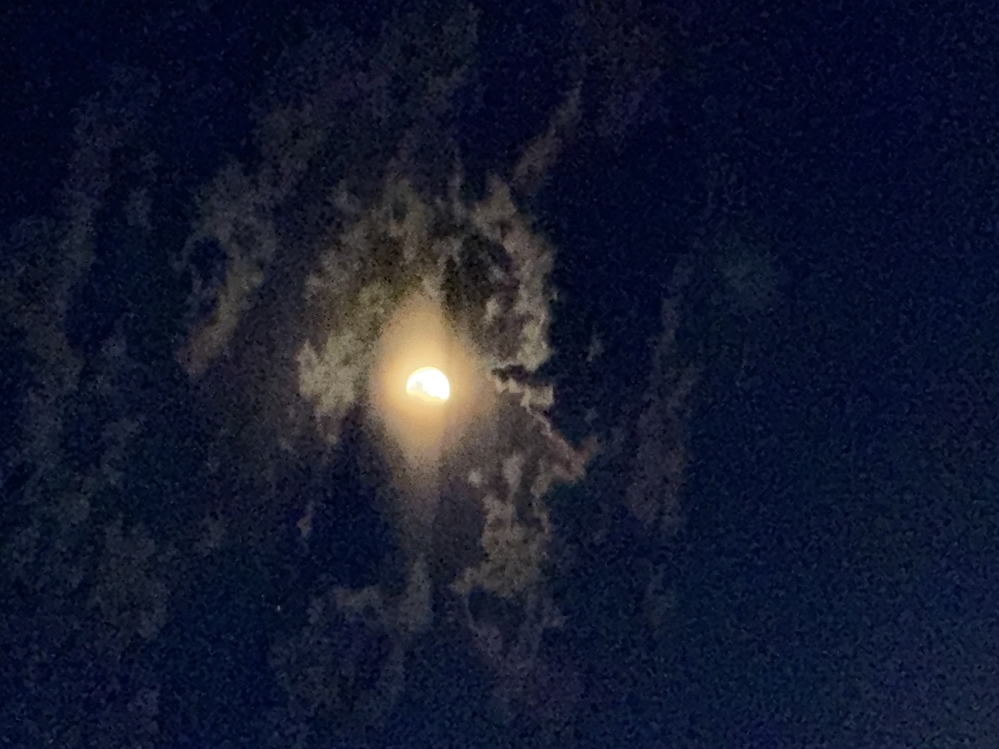 Partial moon with halo effect in Pavlodar's night sky
