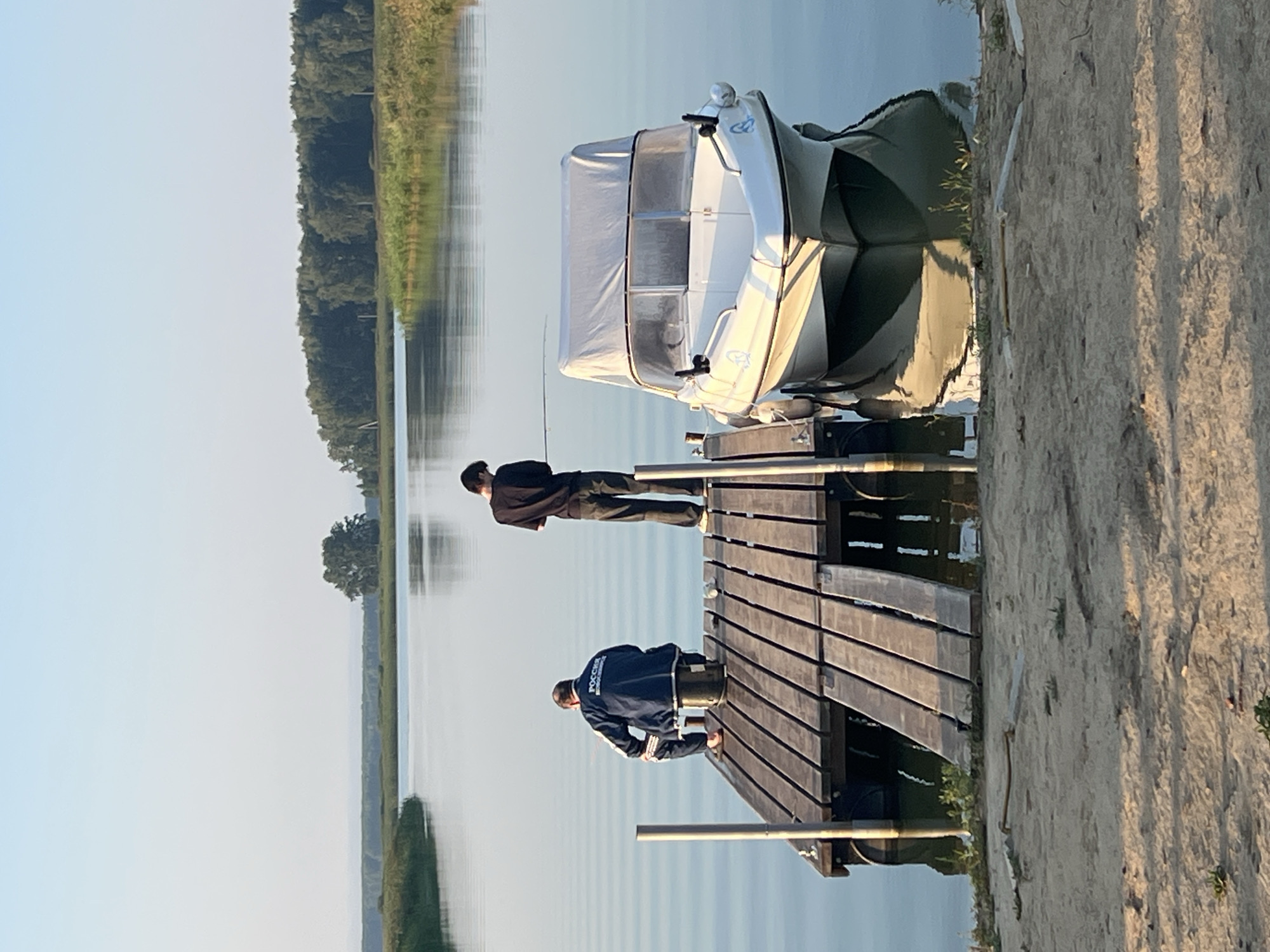 Pier and docked boat on a calm Russian lakeside evening