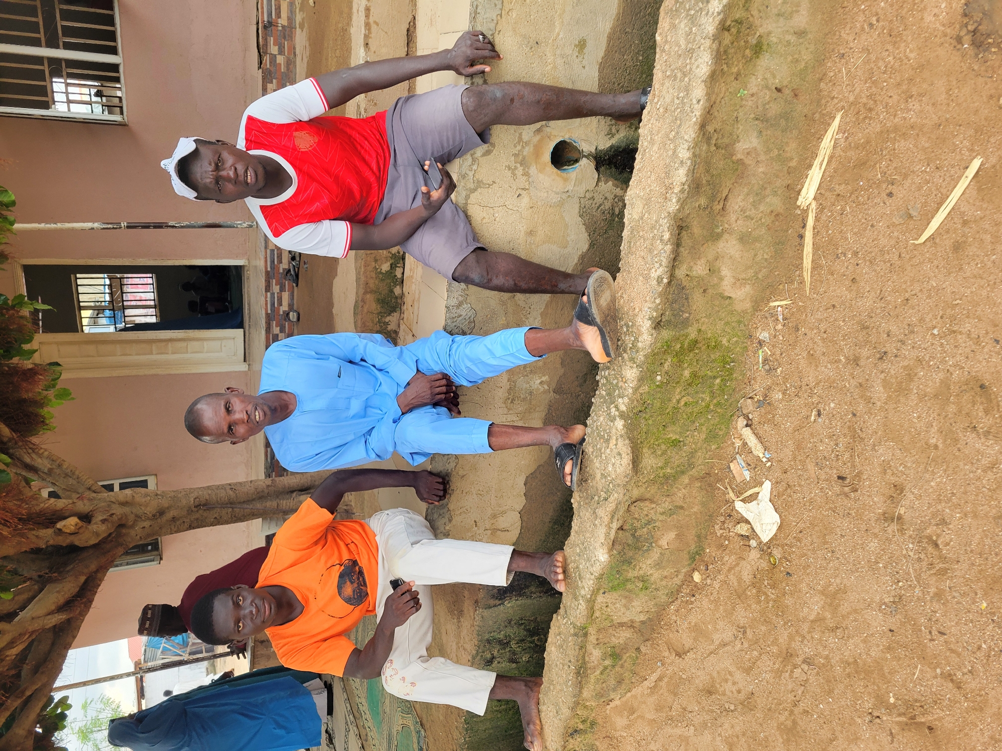 Afternoon street life outside a building in Madalla, Nigeria