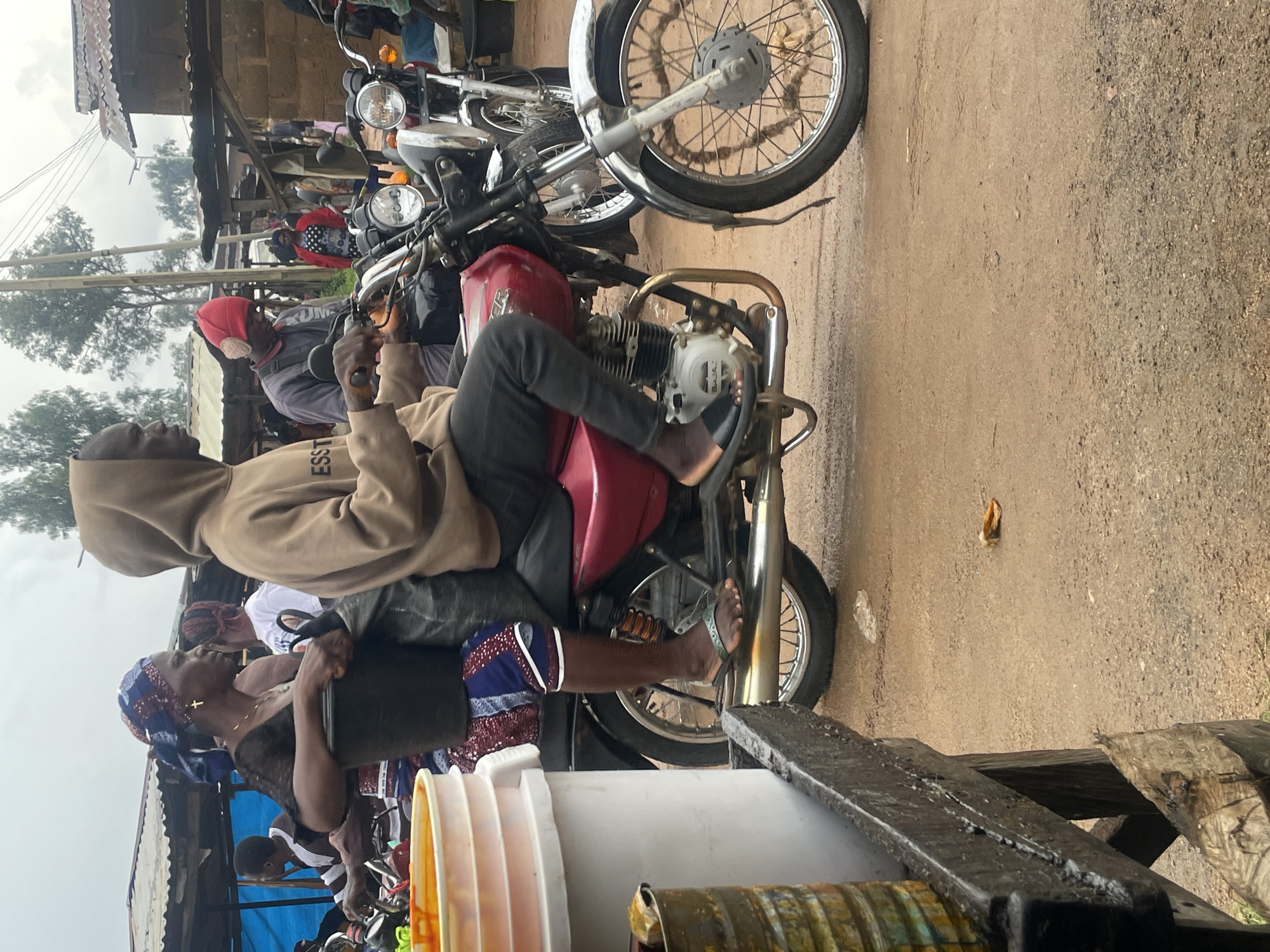 Midday market activity on wet streets in Wang, Nigeria